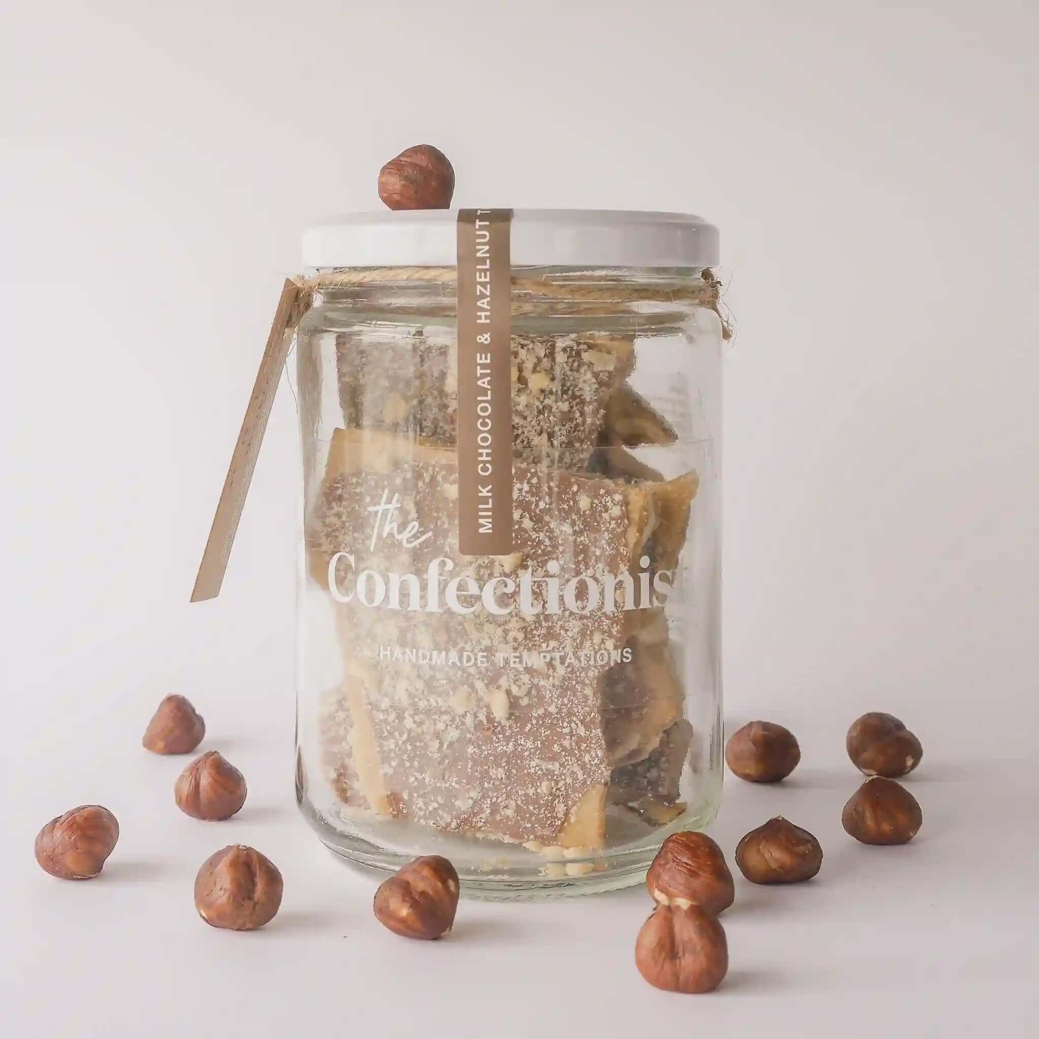 Alt Tag: The Confectionist Milk Chocolate Hazelnut Toffee - Large handcrafted toffee in glass jar with roasted hazelnuts, 200g gift treat