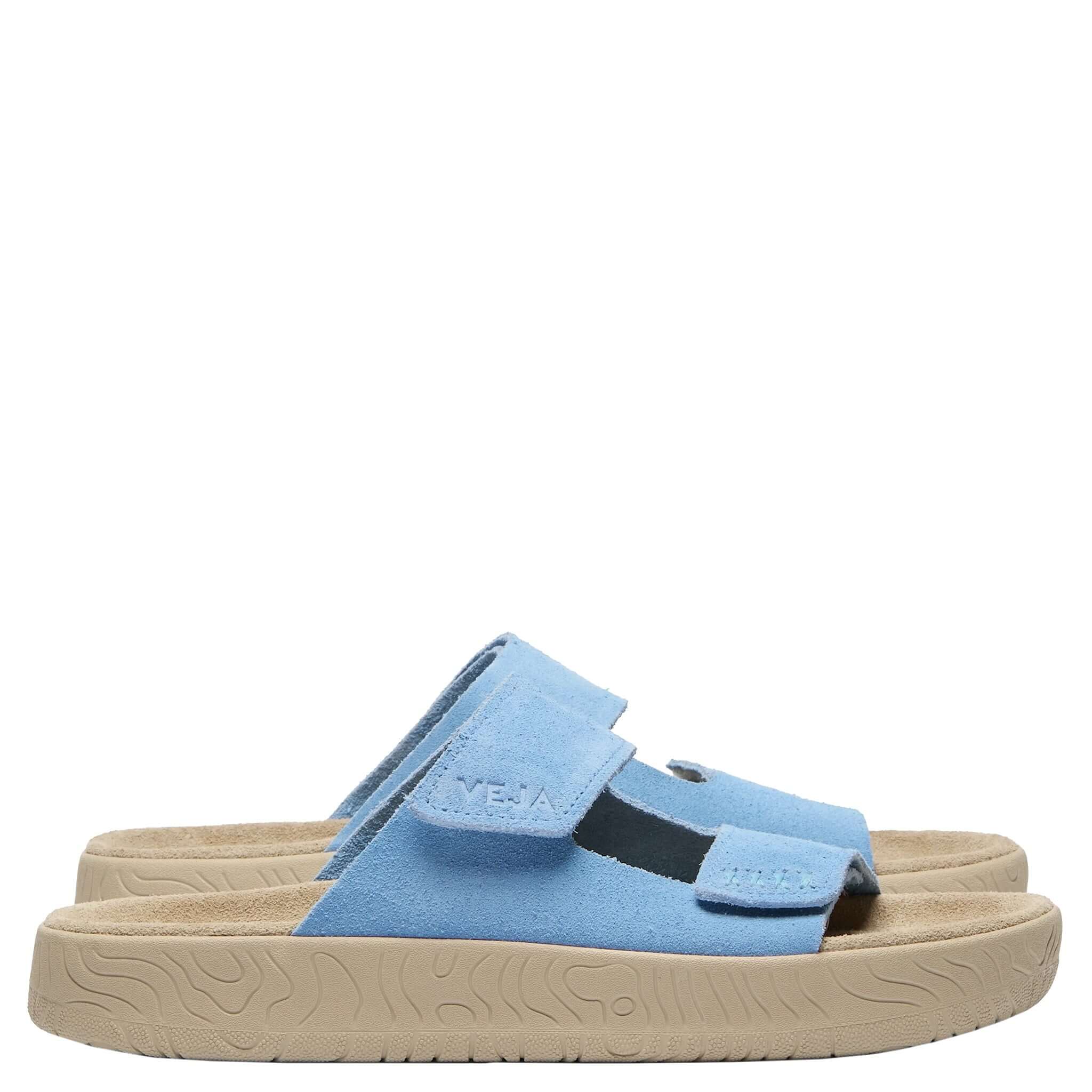 Blue sandal with a beige sole on a white background