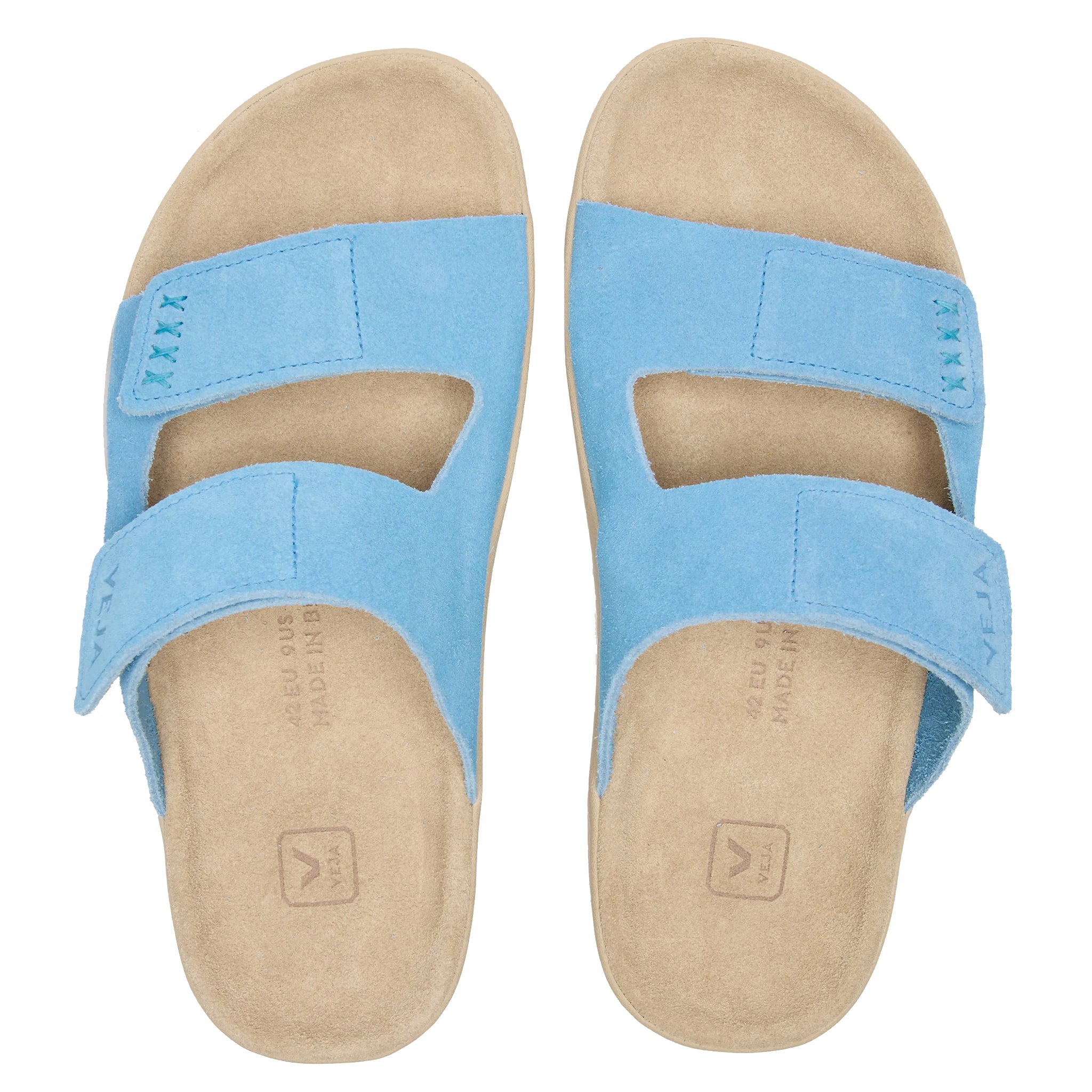 Pair of blue sandals with beige soles on a white background