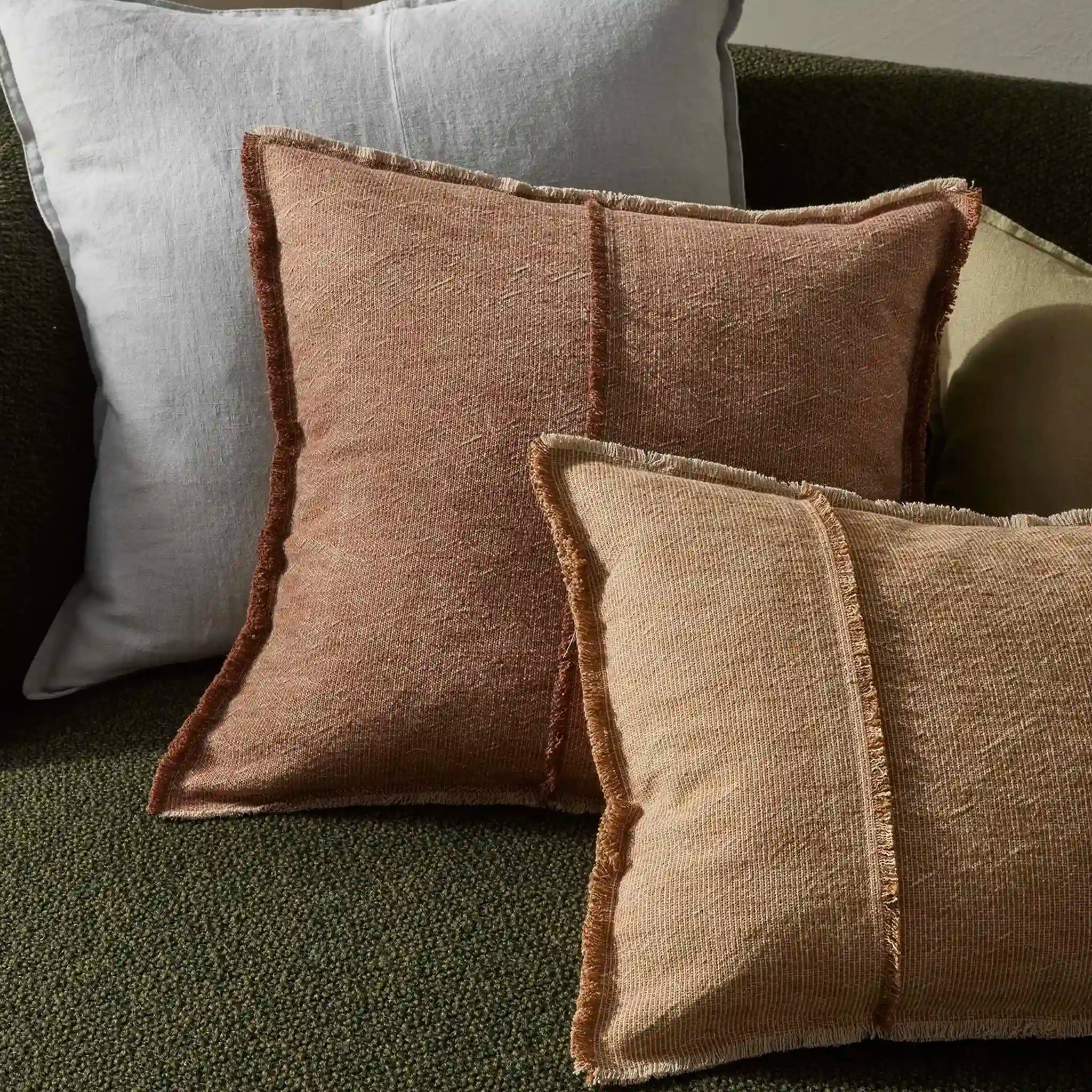 Textured throw cushions in brown and gray on a sofa