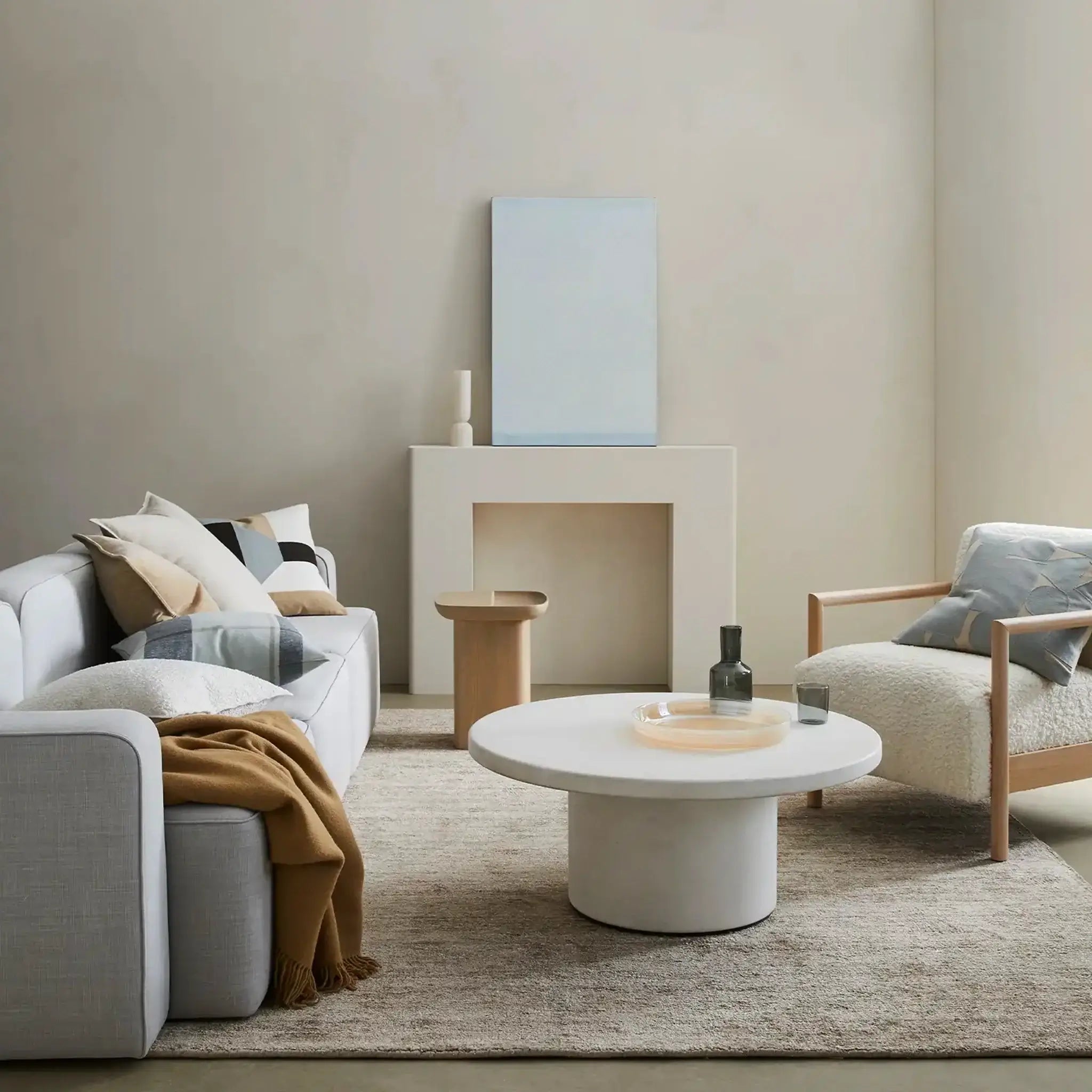 Modern living room with a sofa, coffee table, and armchair.