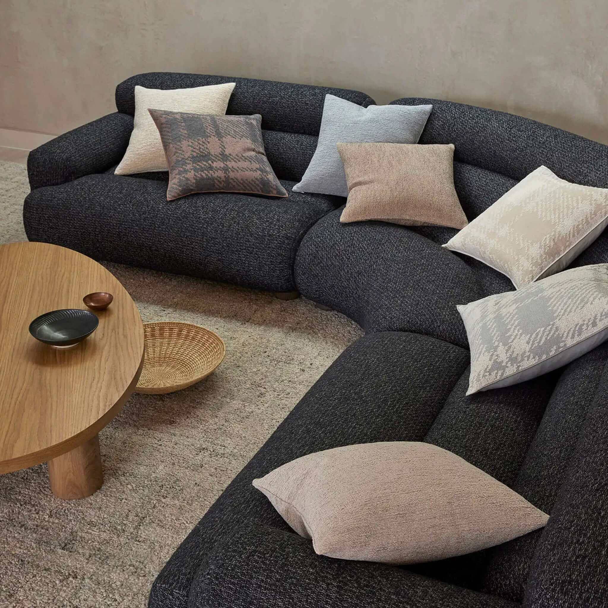 Gray sectional sofa with cushions in a living room setting