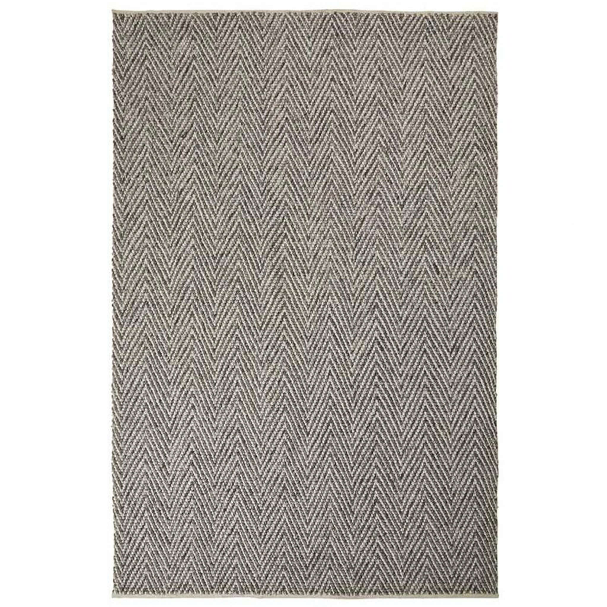 Gray and white chevron patterned rug on a white background