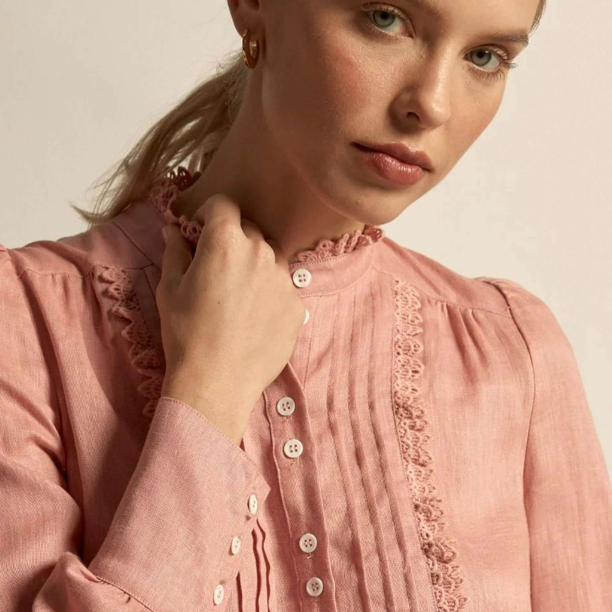 Alt Tag: Zoe Kratzmann Haze Top - Camellia pink linen blouse close-up with lace-trim bib and button-through front