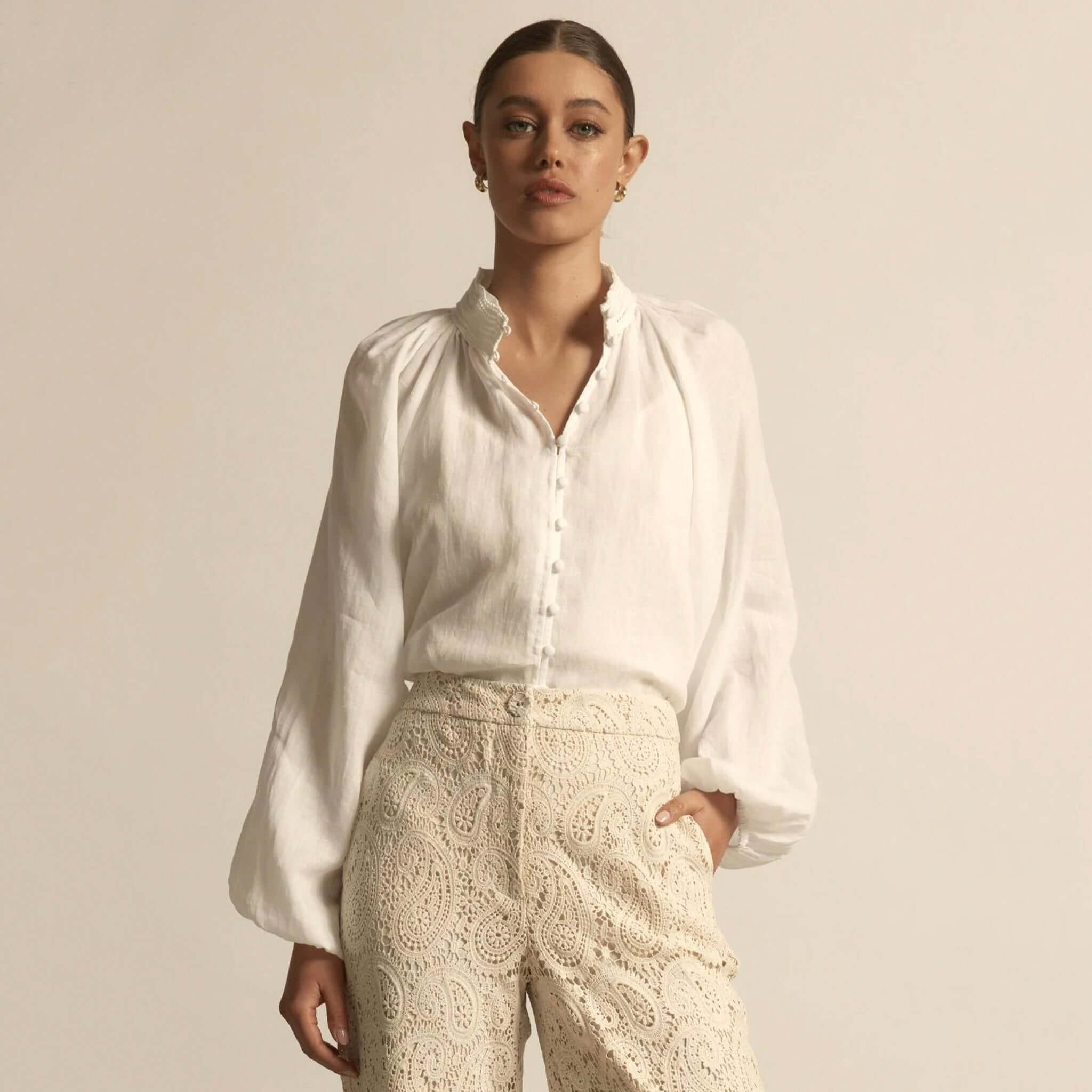 Alt Tag: Zoe Kratzmann Solstice Top - Porcelain white ramie blouse with lace high neckline and raglan sleeves, front view on model