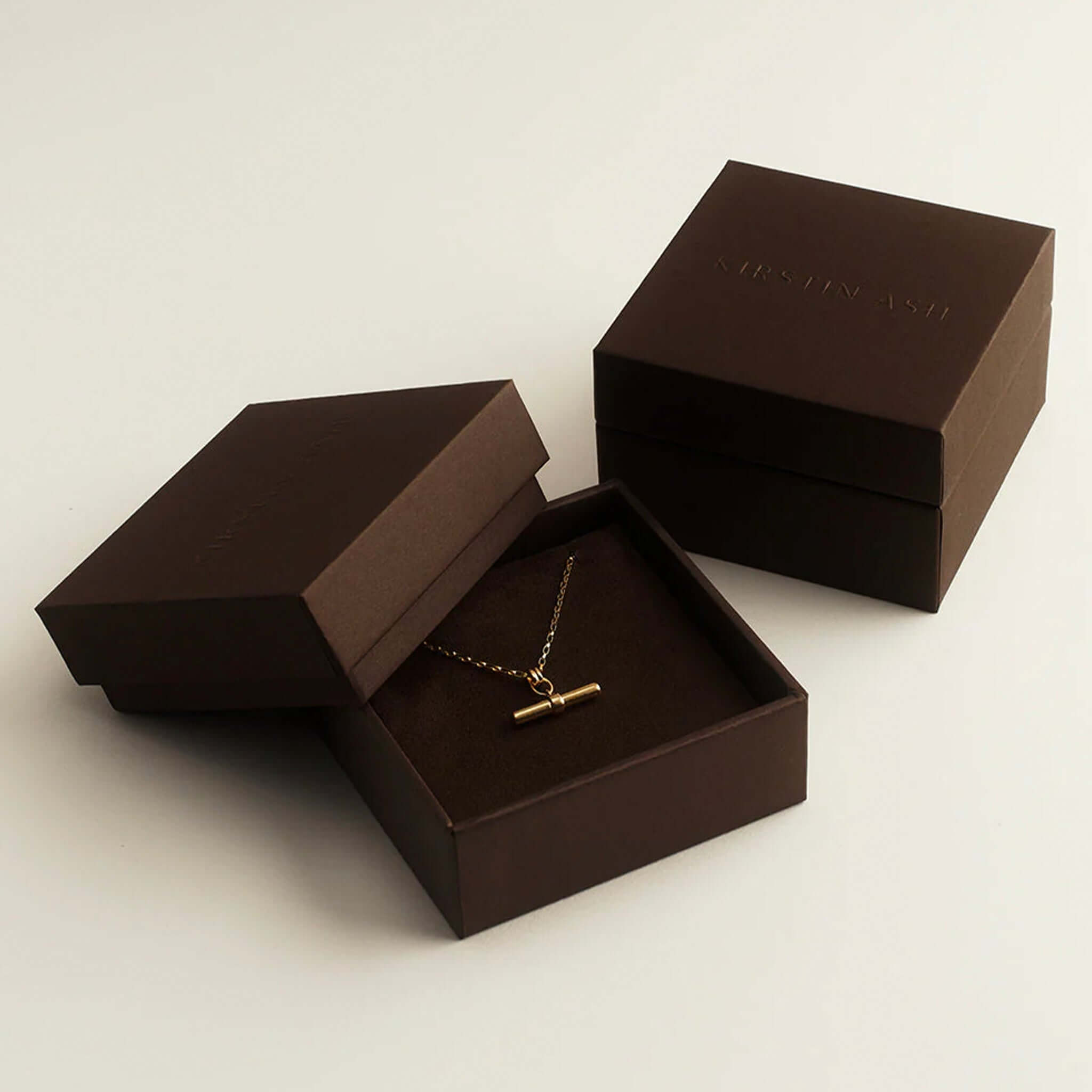 Kirstin Ash Ember Collection Symphony Hoop Earrings Small in elegant packaging with gold necklace.