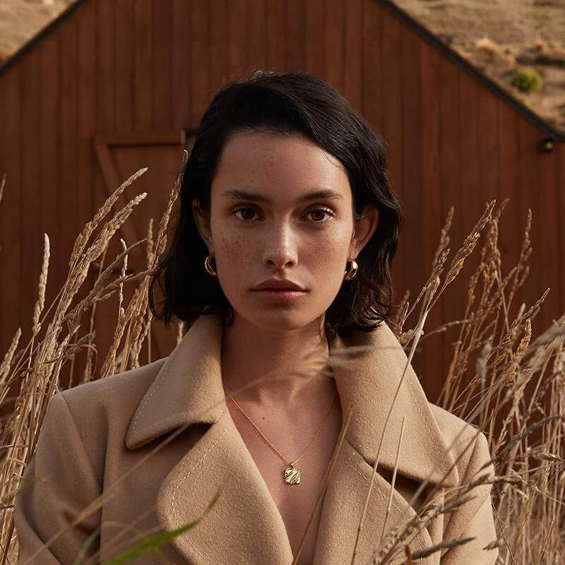 Alt Tag: Kirstin Ash In Between Collection Glow Hoops Earrings on model in outdoor dusk light, minimalist hoop earrings in sterling silver or 18k gold vermeil