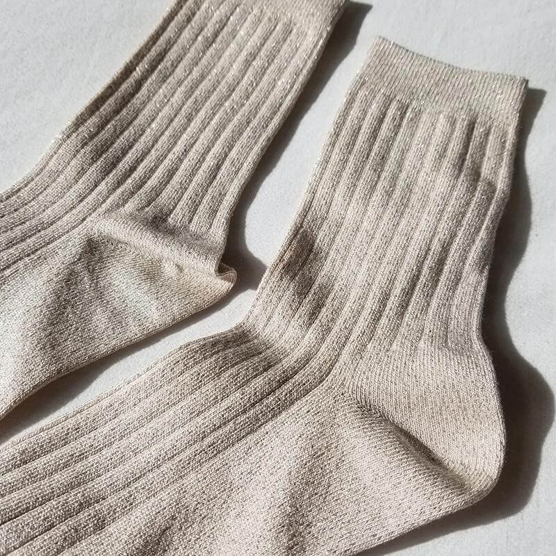 Le Bon Shoppe Her Lurex Socks - Ivory Gold Glitter displayed on a soft surface, showing ribbed texture and shimmering detail.