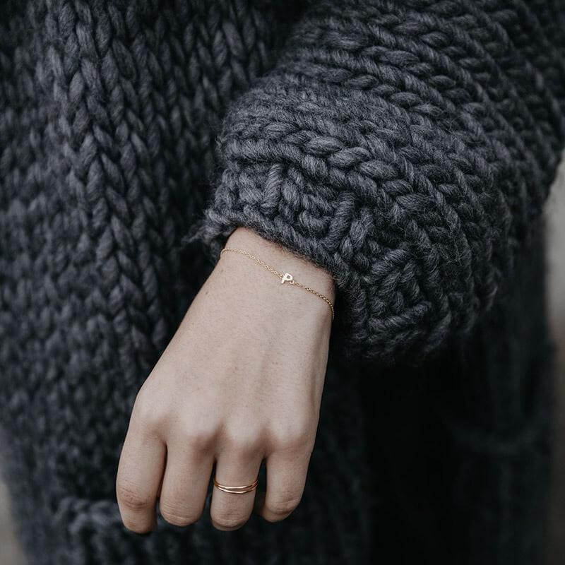 Alt Tag: Sophie Little Letter Bracelet - 14K Gold Plated initial charm bracelet on wrist, delicate gold-plated sterling silver chain, everyday layering