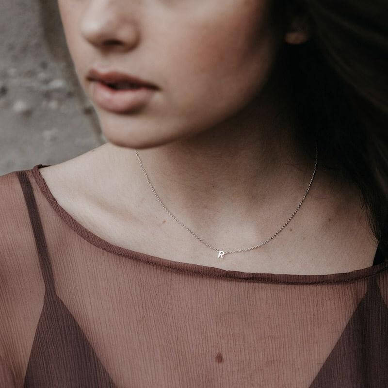 Sophie Little Letter Necklace - 14K Gold Plated initial R pendant on model, delicate adjustable gold-plated sterling silver chain