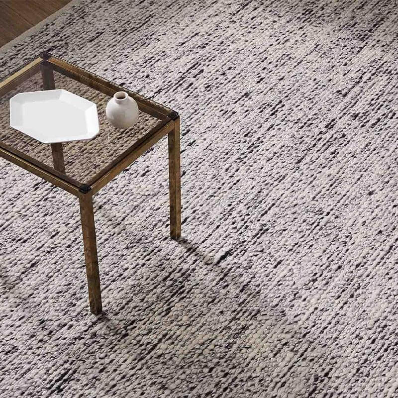 Side table on a grey rug.
