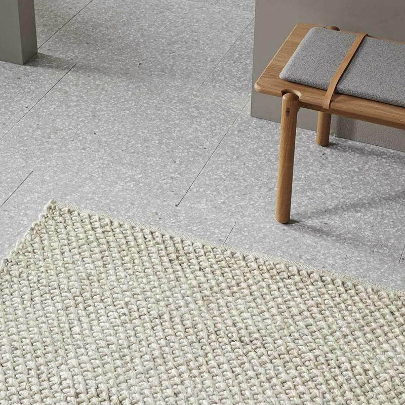 Beige rug on a tiled floor