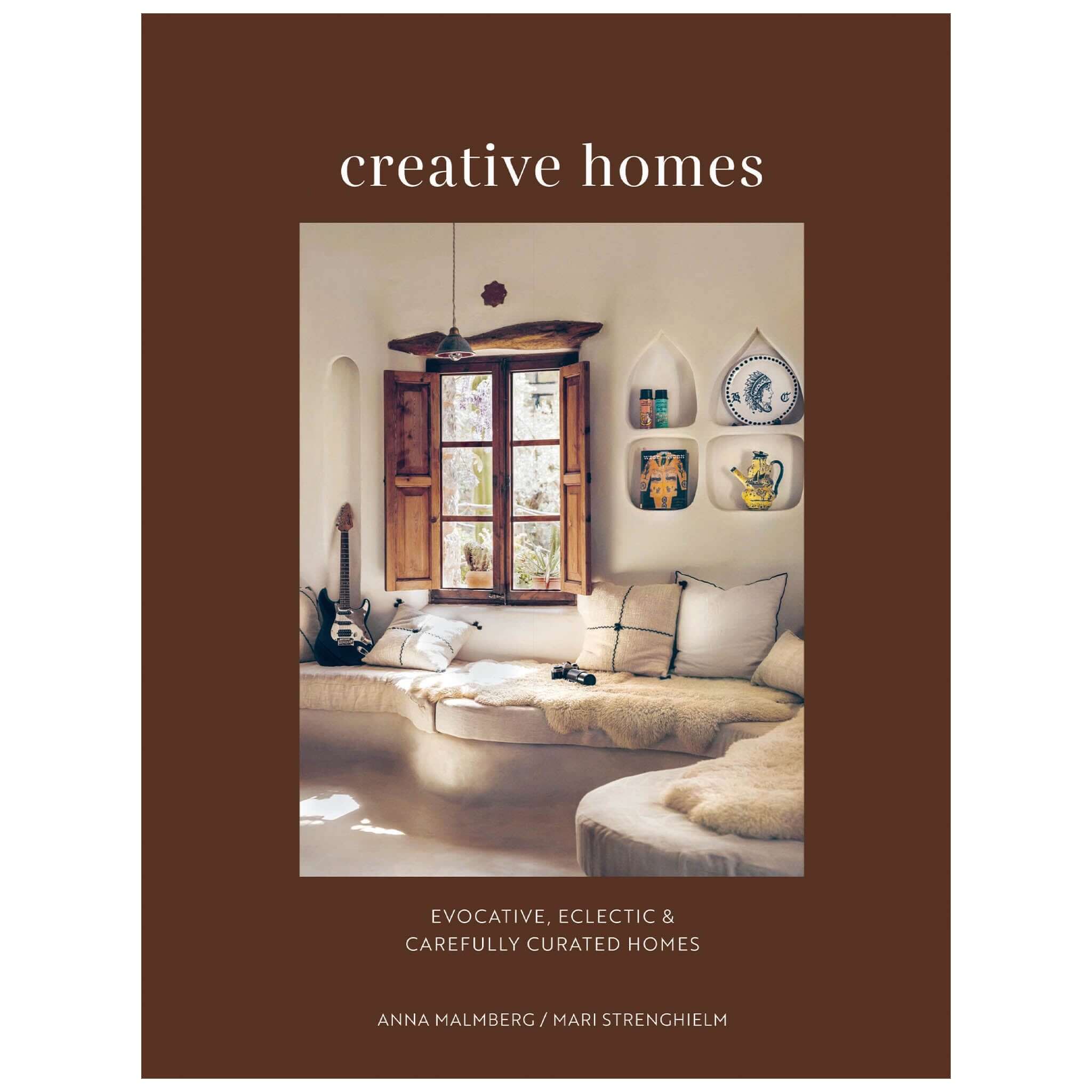 Creative Homes: Evocative, Eclectic & Carefully Curated Interiors book cover with cozy eclectic living room, rustic window and curated decor