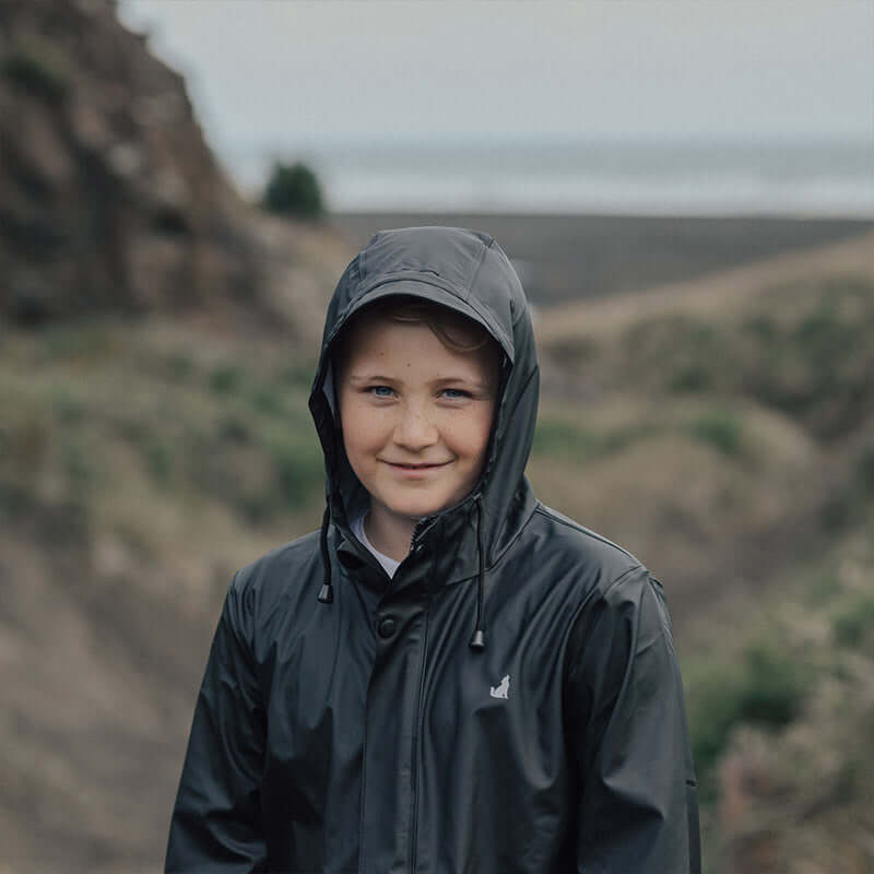 Alt Tag: Crywolf Play Jacket - Black kids waterproof windproof recycled rain jacket with hood, lightweight unisex outdoor playwear