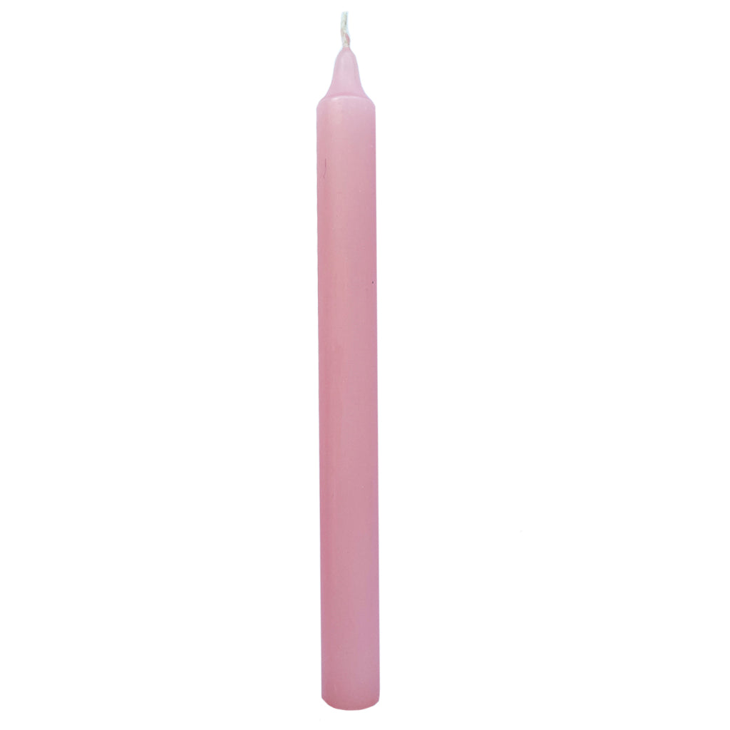 Pink taper candle on a white background