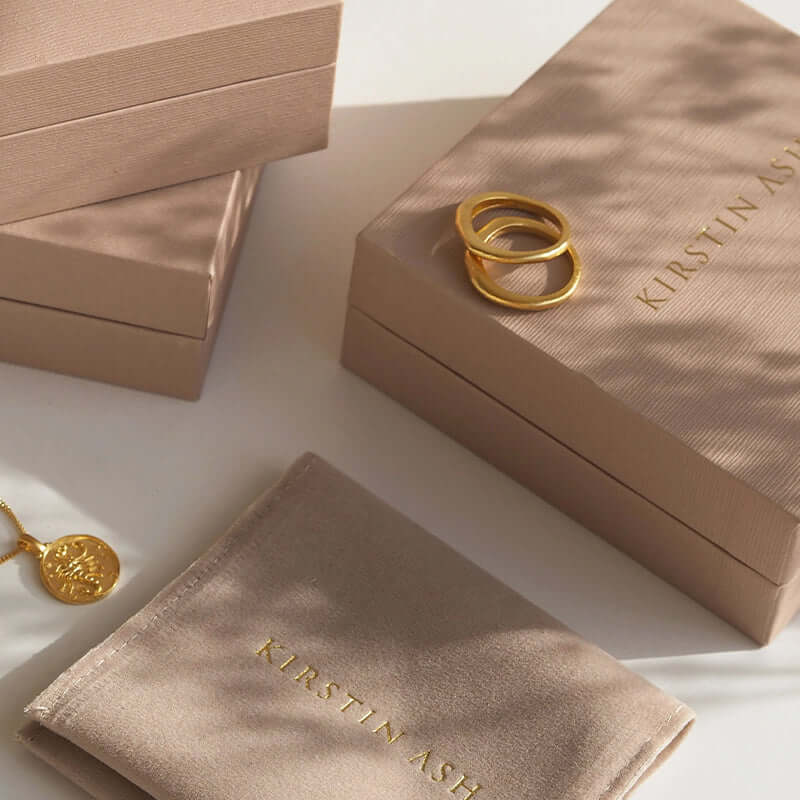 Alt Tag: Kirstin Ash Bespoke Collection Adjustable Curb Bracelet - Sterling Silver jewelry gift boxes and pouch flat lay