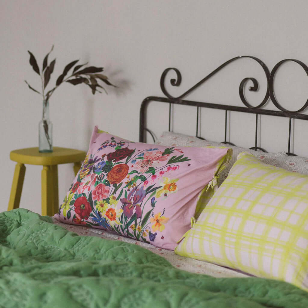 Alt Tag: Lazybones Organic Cotton Pillowslip Set - Rainbow Floral double-sided pillowcases on bed with Nathalie Lete floral print