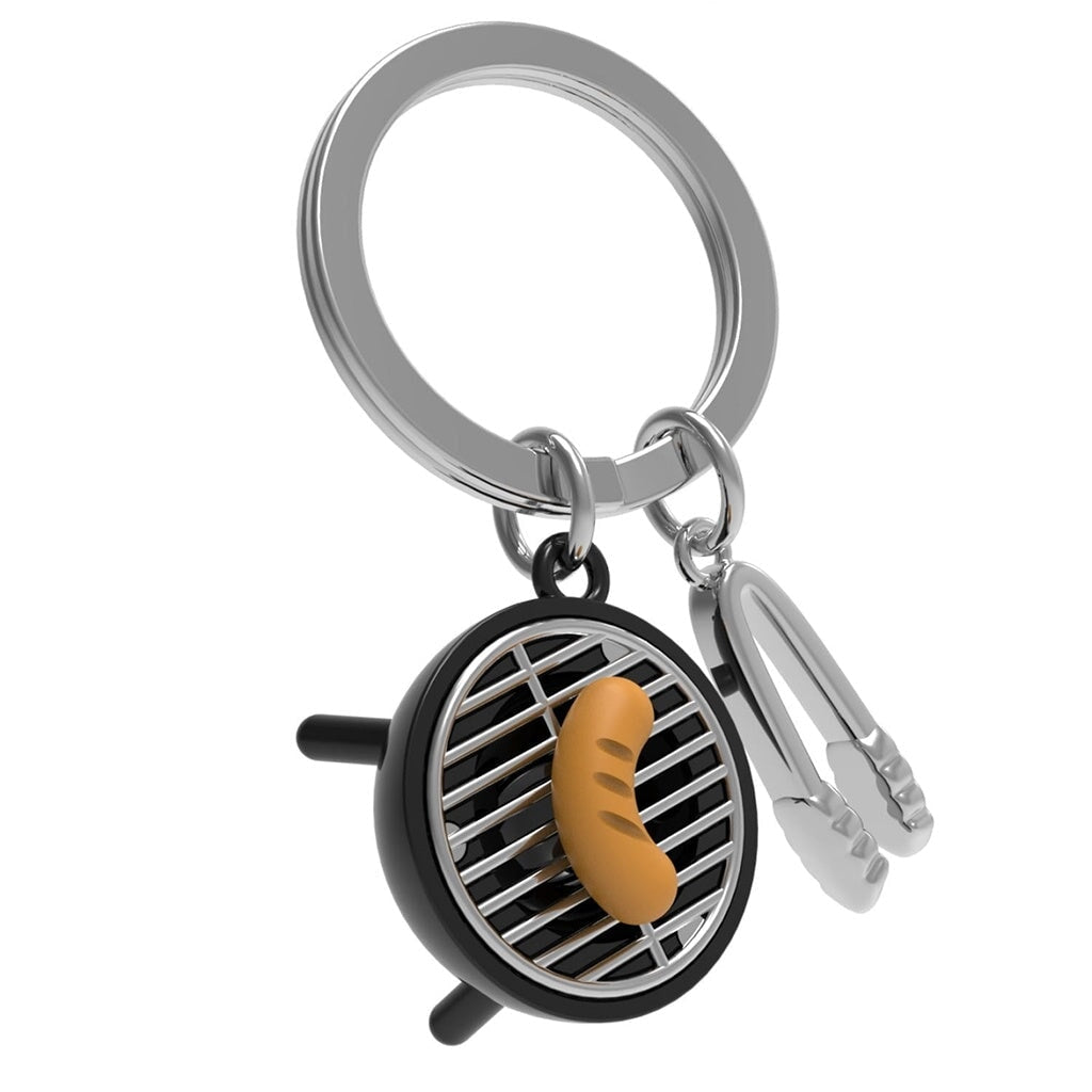 Black BBQ and silver tongs keychain on a white background