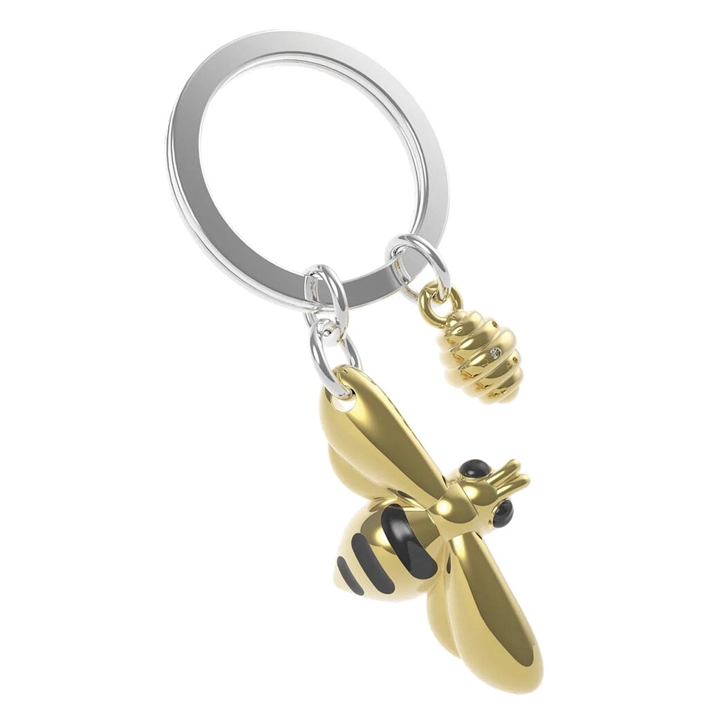 Gold honeybee and hive keychain on a white background