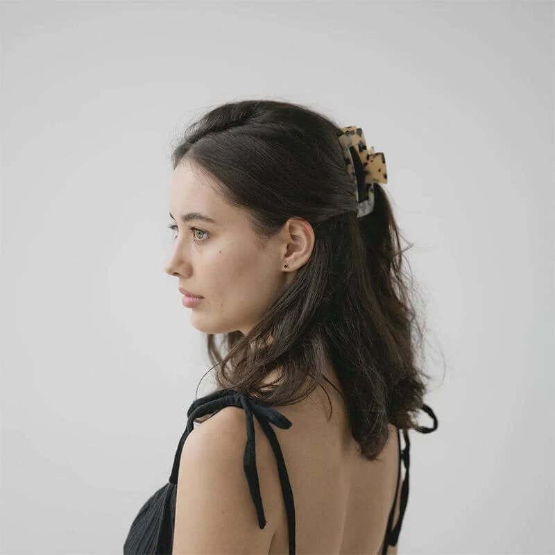 Alt Tag: Sophie Claw Clip Large - Ivory styled in hair, light tort acetate claw clip holding half-up hairstyle