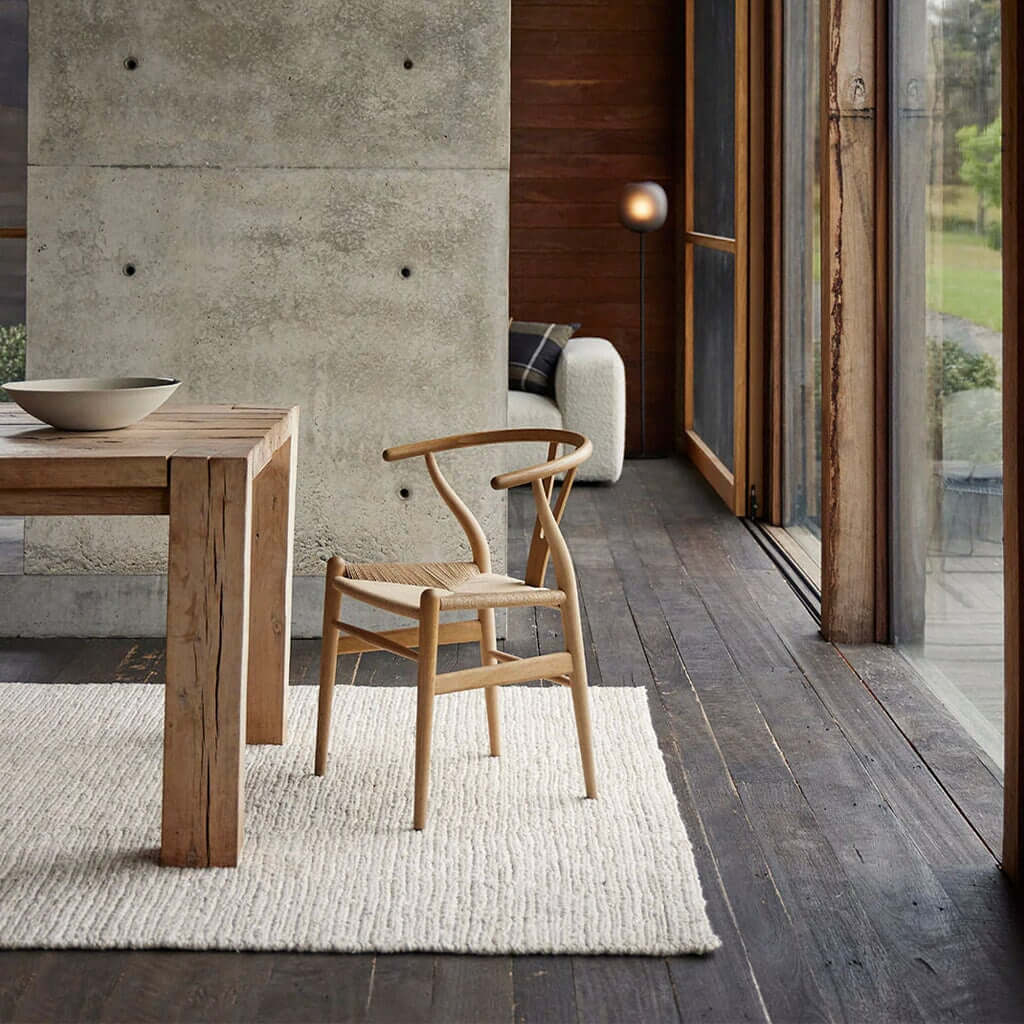 Weave Suffolk rug in a room with a table and chair.