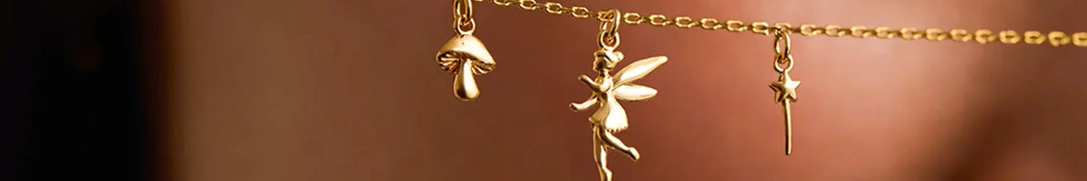 Estella Bartlett gold heart hoop earring close-up on ear, minimalist London jewellery accessory