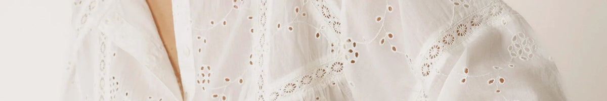 Indi & Cold cream blouse detail with embroidered panel and buttons, contemporary Spanish fashion with relaxed feminine style