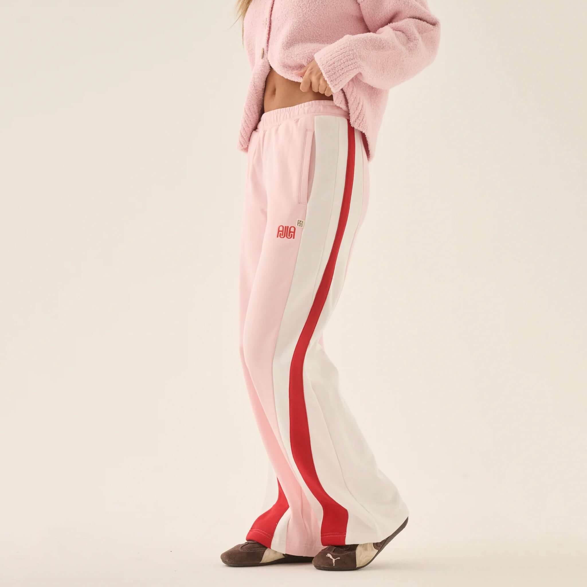 Araminta James Mallorca Trackpants - Ballet Pink on model showcasing elegant wide leg design.