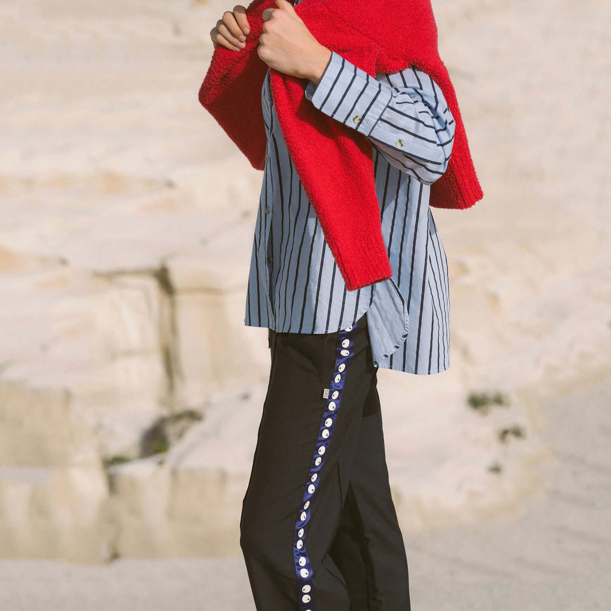 Araminta James Pomodoro Twill Pants - Midnight Navy styled with a blue striped shirt and red sweater.