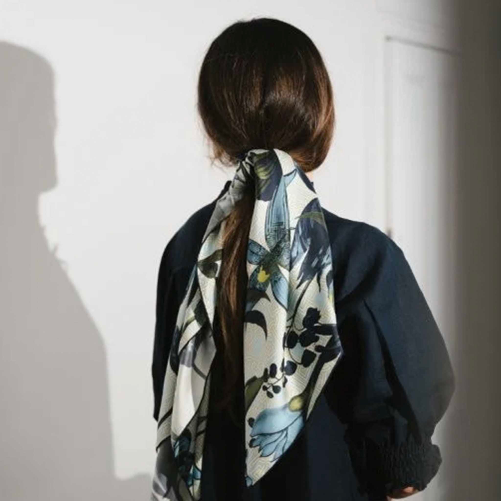 Alt Tag: Artifact Square Silk Scarf - Eos worn as a hair scarf, blue and yellow botanical print on cream geometric silk twill