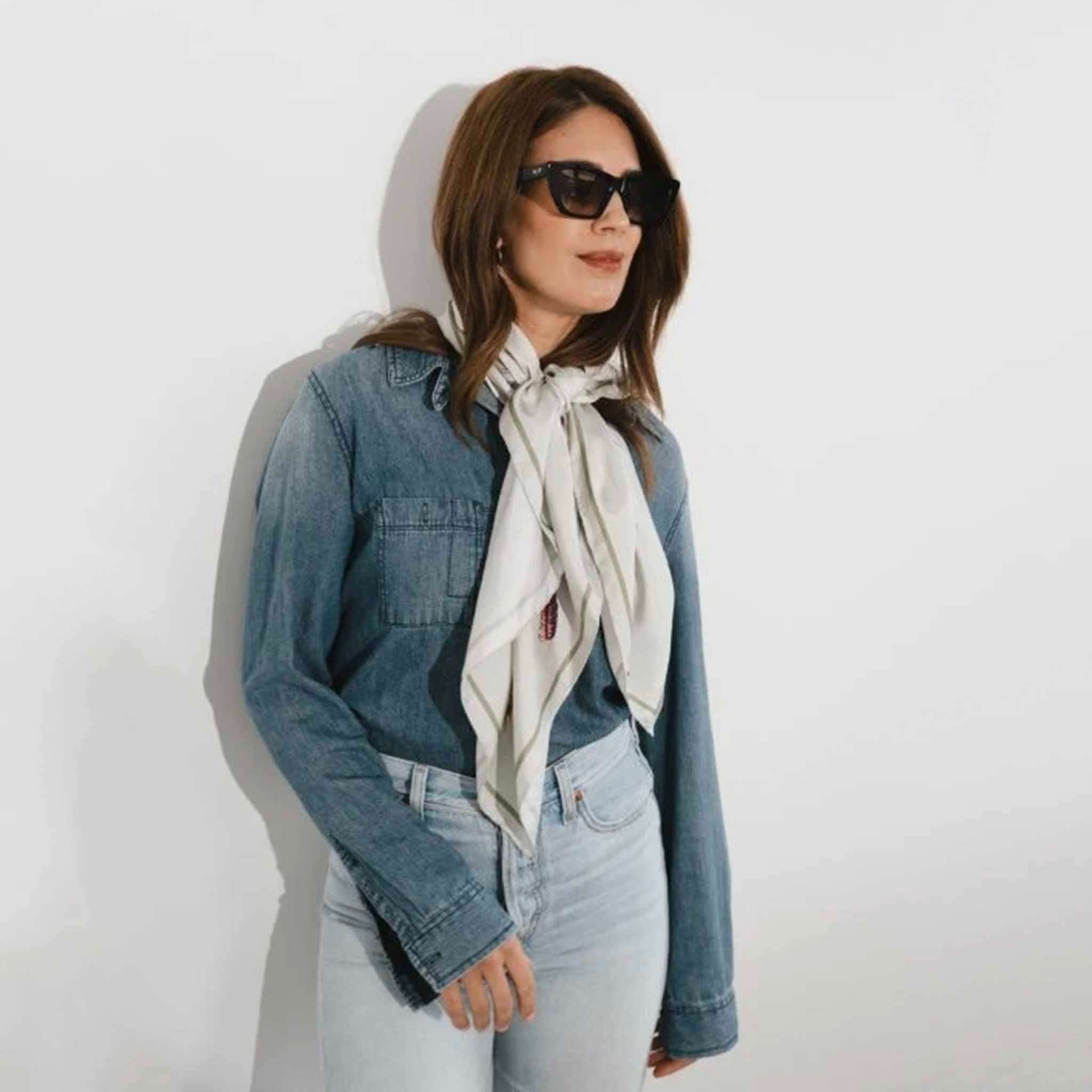 Alt Tag: Artifact Square Silk Scarf - Pomona Grove styled as a neck scarf on a woman wearing denim jacket and sunglasses