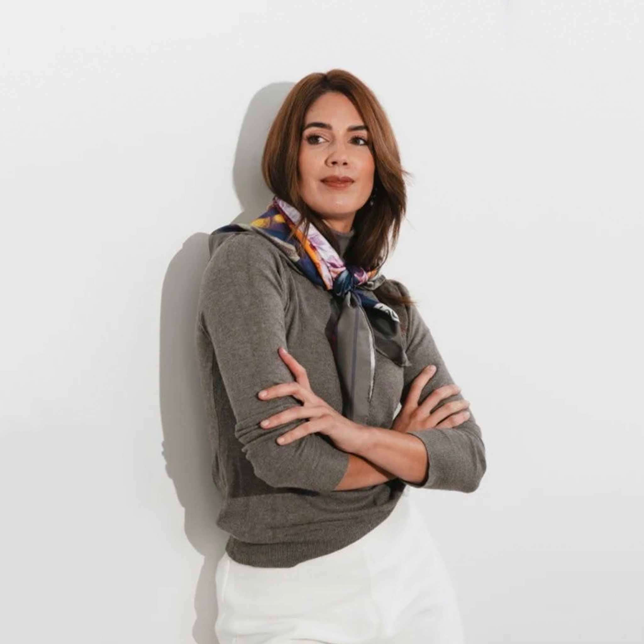 Artifact Square Silk Scarf - Pomona Harvest worn by model, vibrant botanical fruit print silk scarf styled at neck against neutral background