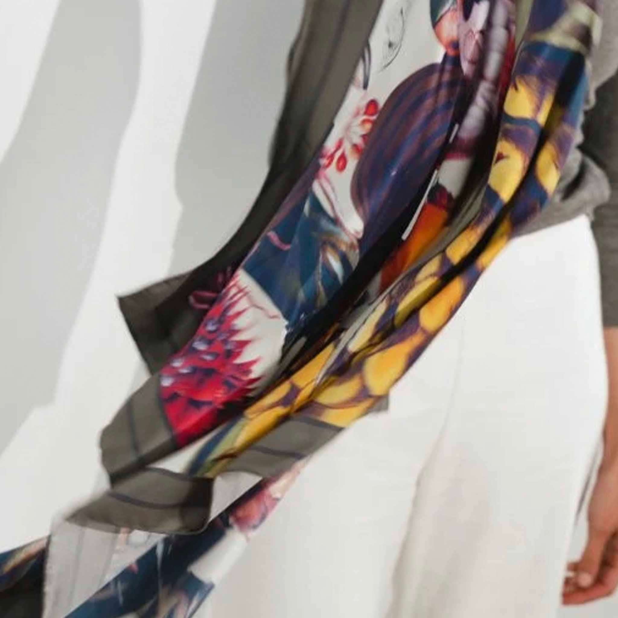 Alt Tag: Artifact Square Silk Scarf - Pomona Harvest with vibrant botanical fruit print, neutral background and earthy border, worn flowing