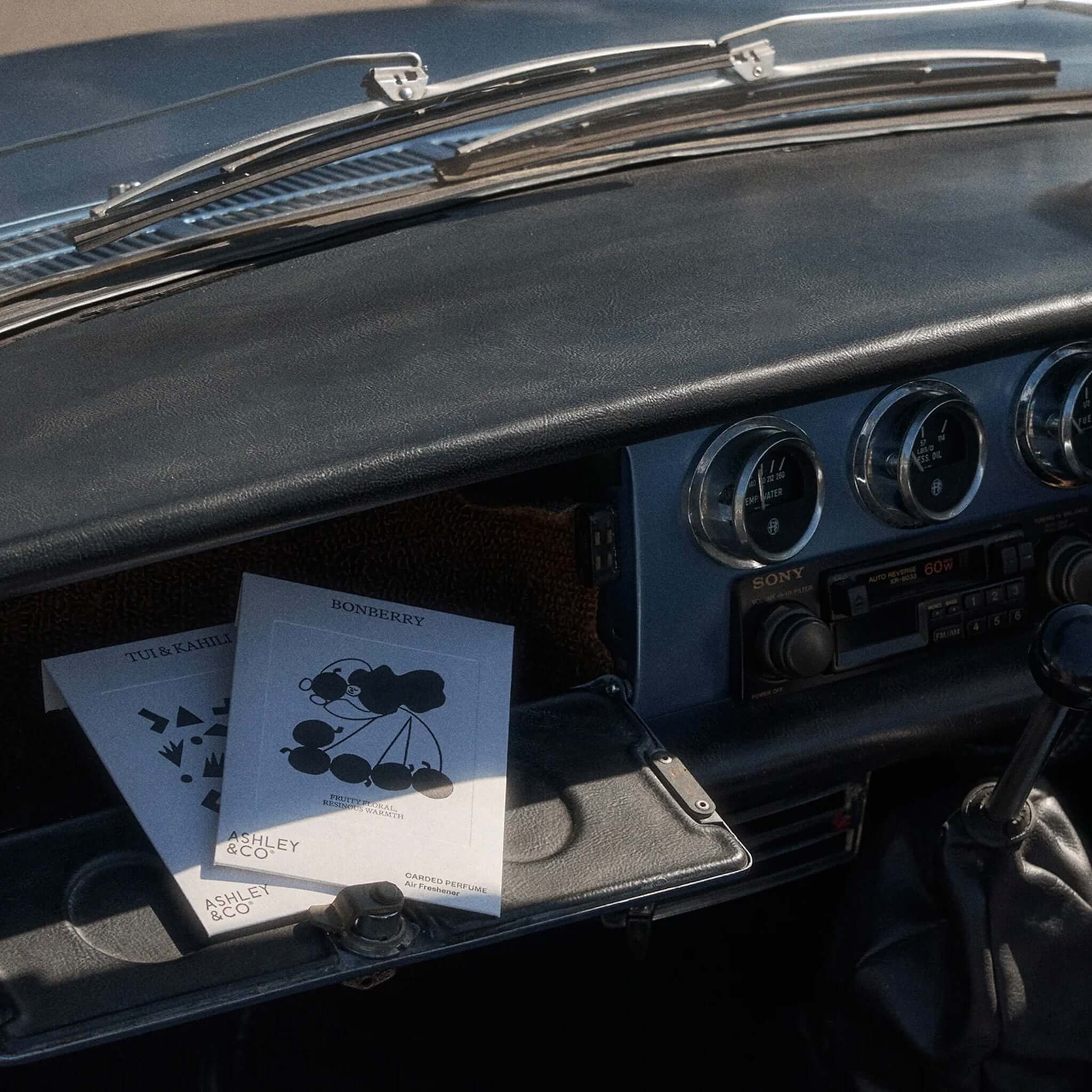 Ashley & Co Carded Perfume Air Freshener - Bonberry carded perfume in car dashboard compartment, portable fruity-floral scent