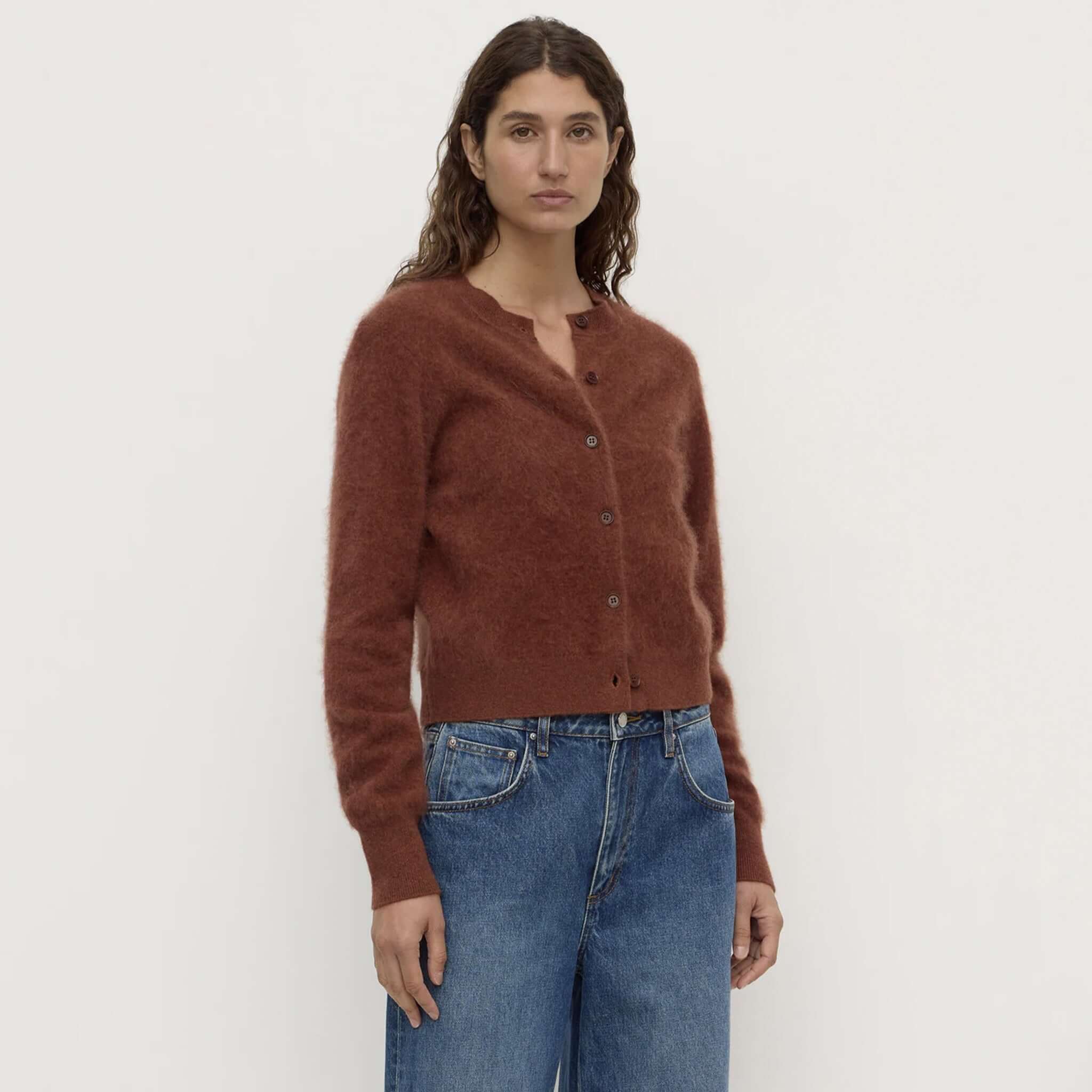 merino wool cardigan Burnt Amber modeled by a woman wearing a stylish outfit with a plush finish.