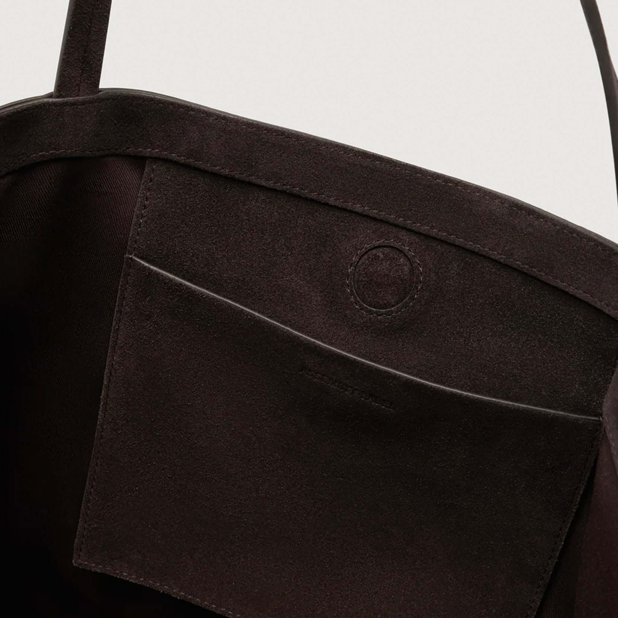 Alt Tag: Assembly Label Paige Suede Tote Bag - Ganache close-up of 100% suede interior pocket with slim strap detail