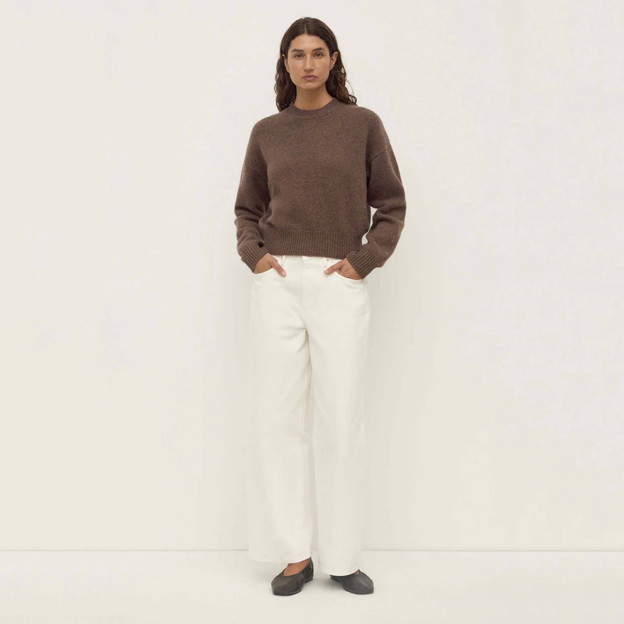 Alt Tag: Assembly Label Benny Wool & Yak Knit Jersey - Cocoa Marle knit sweater on model with white trousers, full-length front view