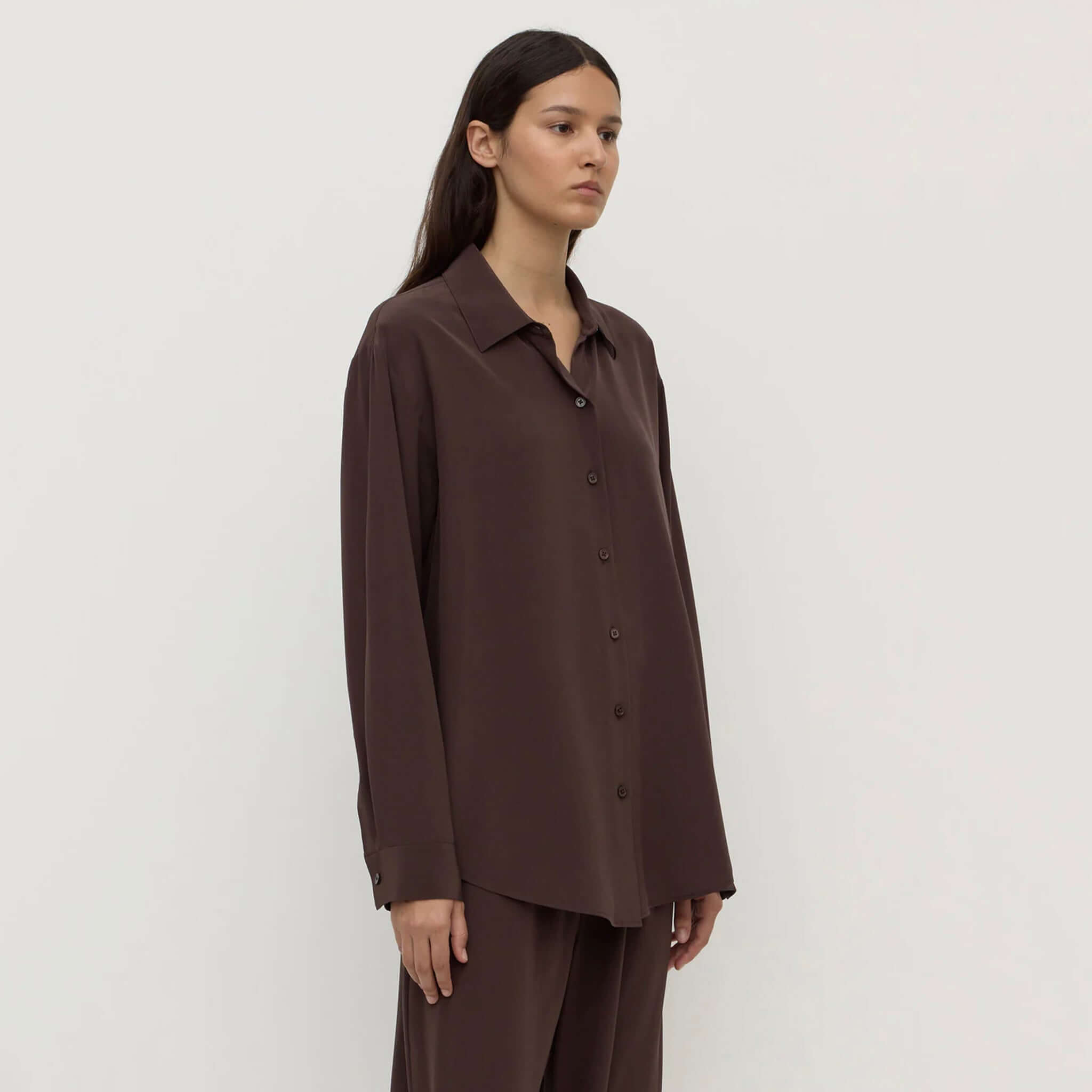 Alt Tag: Assembly Label Betty Silk Long Sleeve Shirt - Ganache on model, lightweight silk button-up long sleeve shirt in rich brown