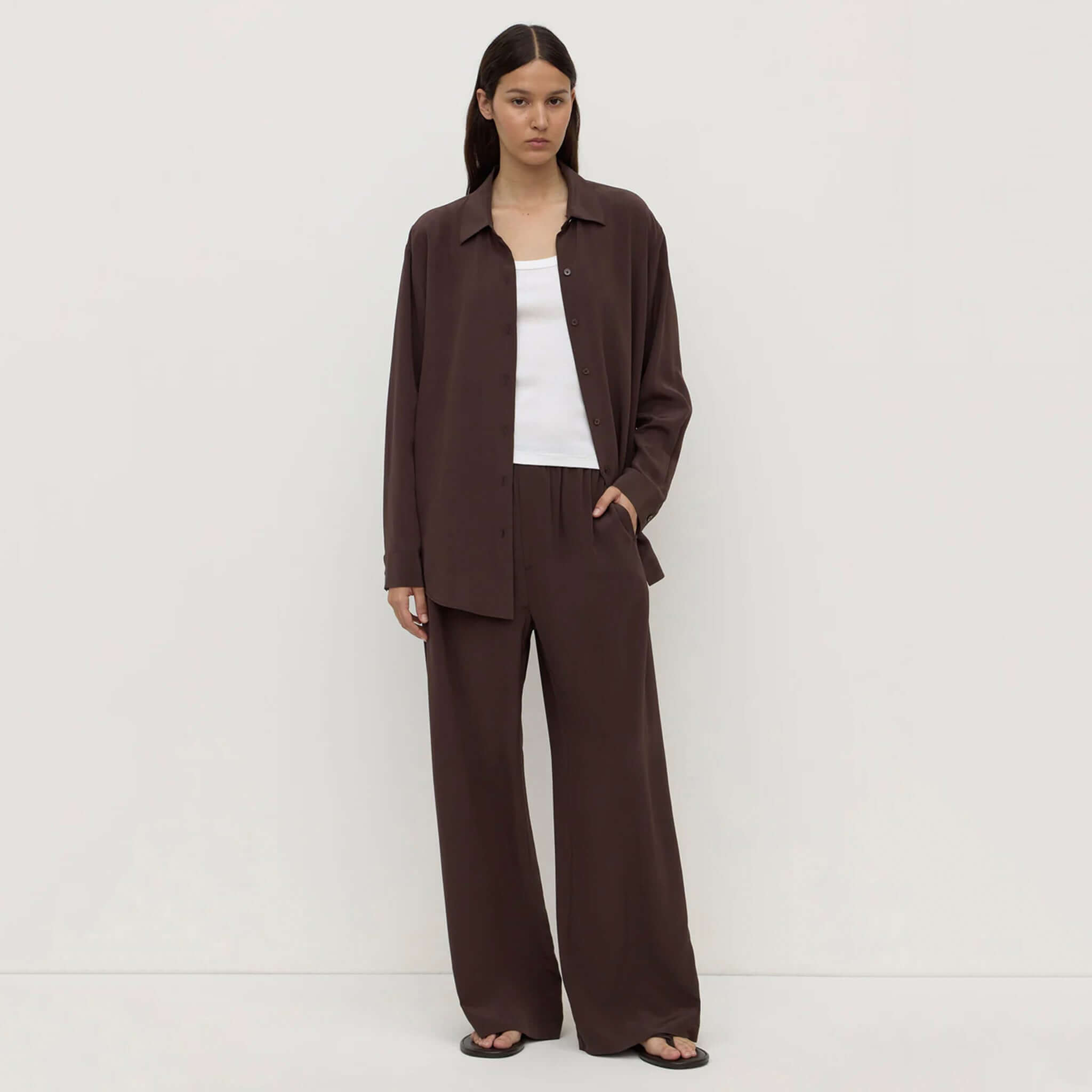 Alt Tag: Assembly Label Betty Silk Pants - Ganache on model, relaxed straight-leg lightweight silk pants in rich ganache brown