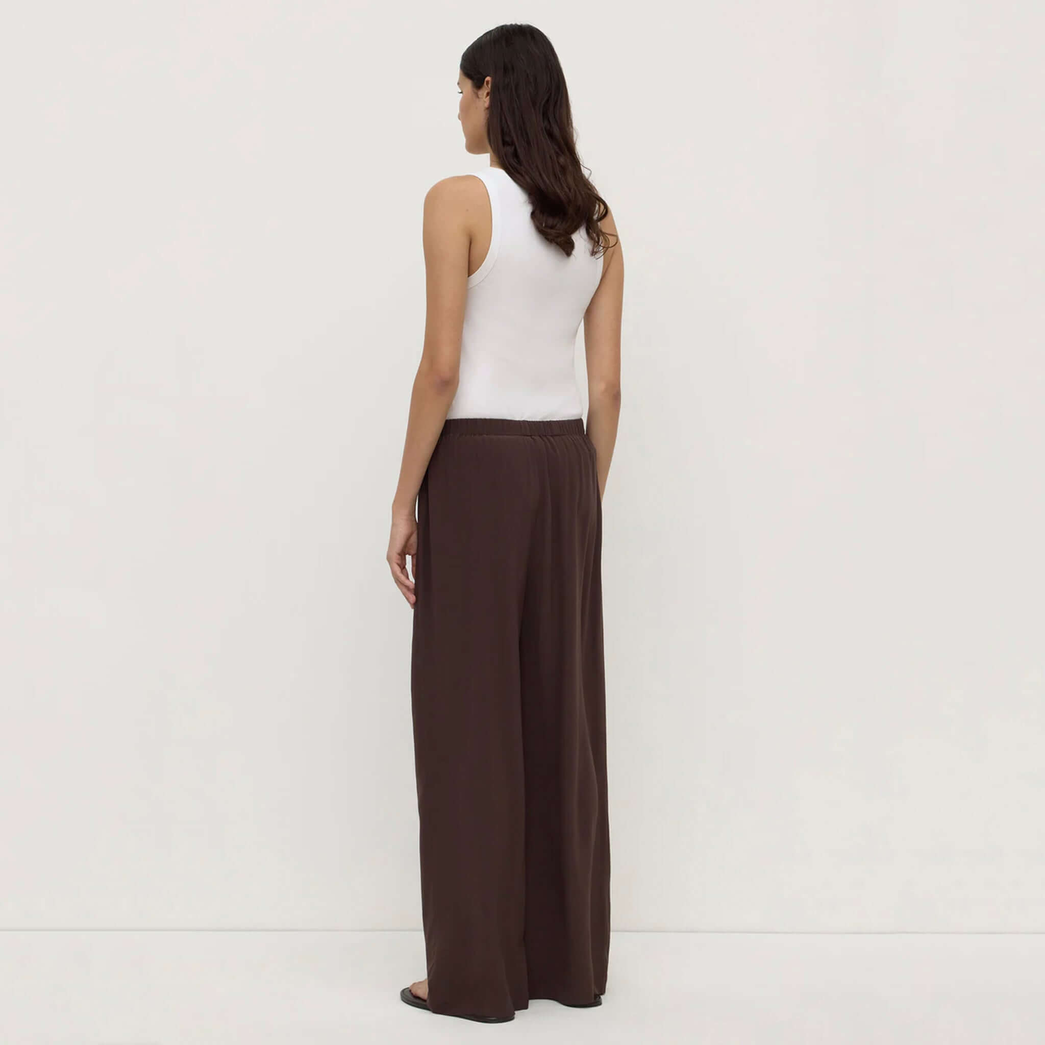 Alt Tag: Assembly Label Betty Silk Pants - Ganache relaxed straight-leg silk pants in rich ganache brown, back view on model