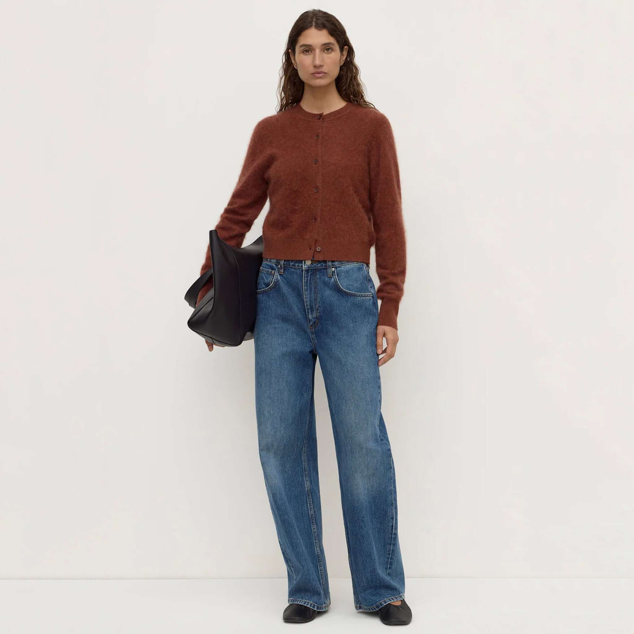 merino wool cardigan Burnt Amber styled with wide-leg jeans and a black bag.