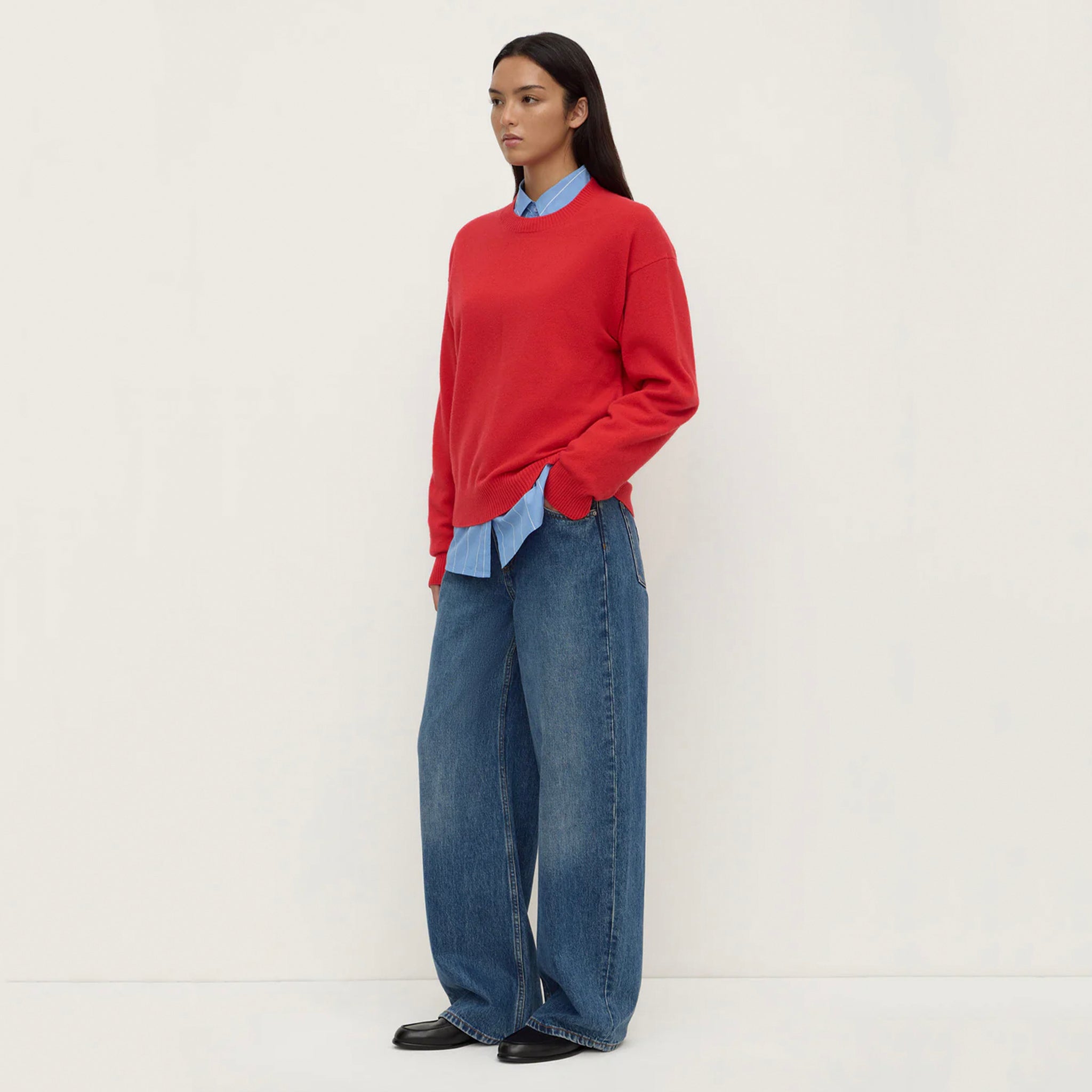 Assembly Label Carter Brushed Merino Wool Sweater - Flame worn with wide-leg jeans and a blue shirt, showcasing a relaxed style.