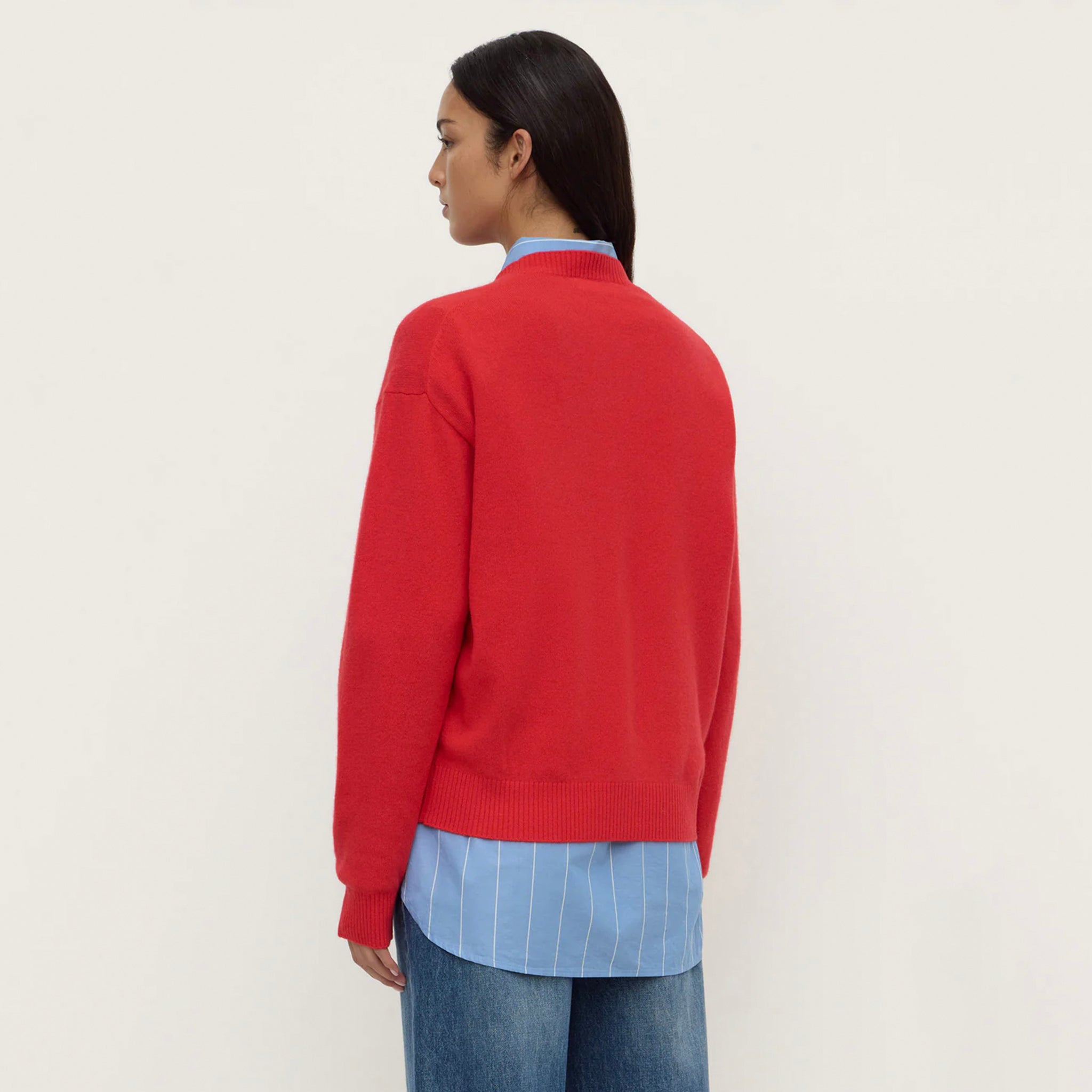 Assembly Label Carter Brushed Merino Wool Sweater - Flame worn with a blue shirt, showcasing its slouchy fit from the back.
