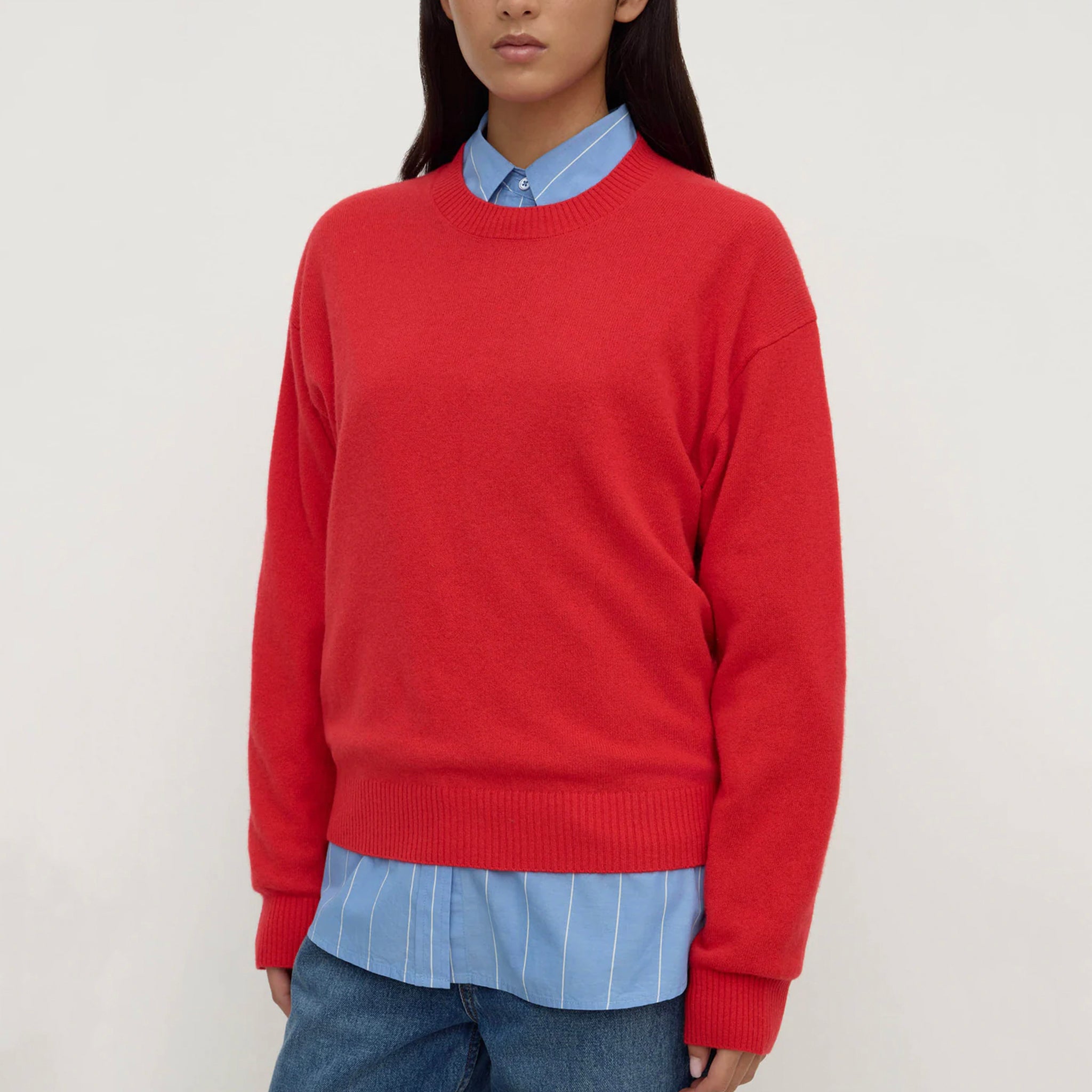 Assembly Label Carter Brushed Merino Wool Sweater - Flame worn over a blue shirt, showcasing its vibrant color and casual style.