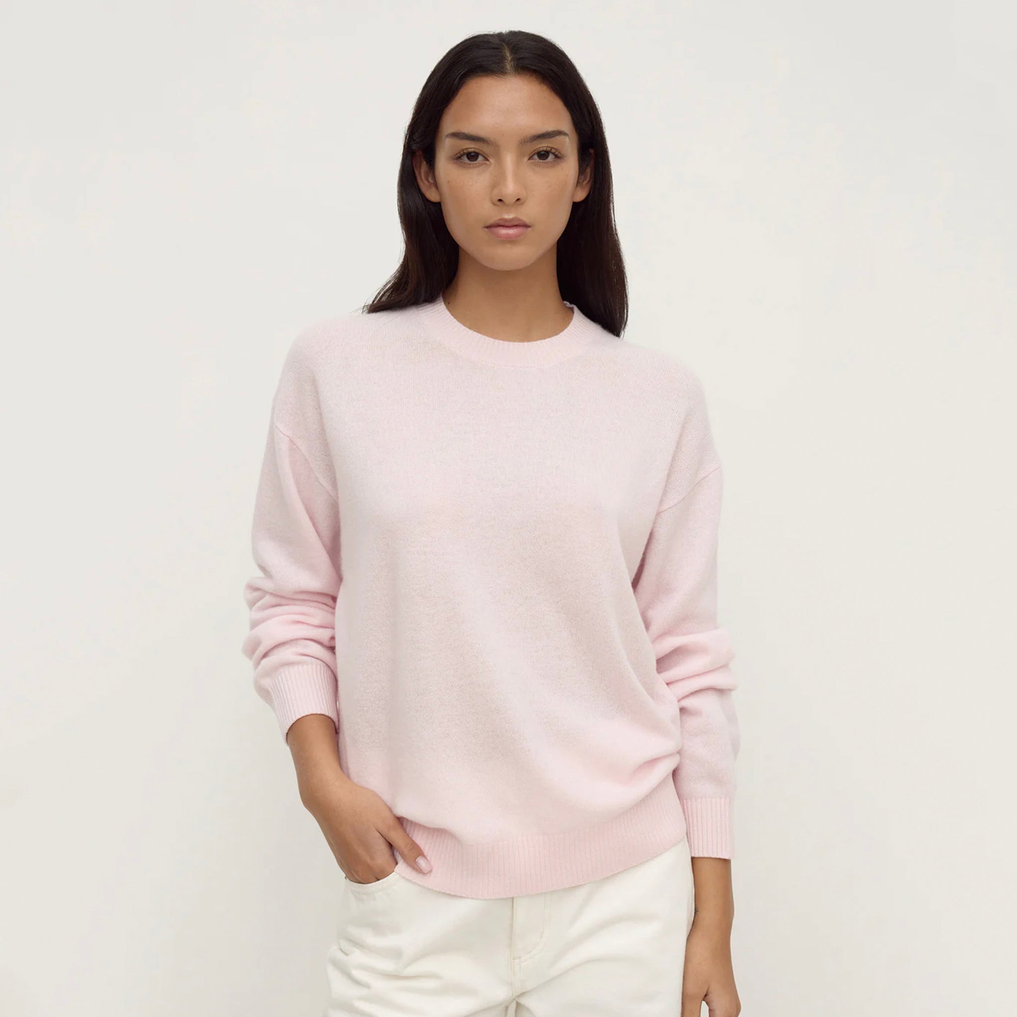 Assembly Label Carter Brushed Merino Wool Sweater - Floss worn by a model, showcasing a slouchy fit and soft pink color.