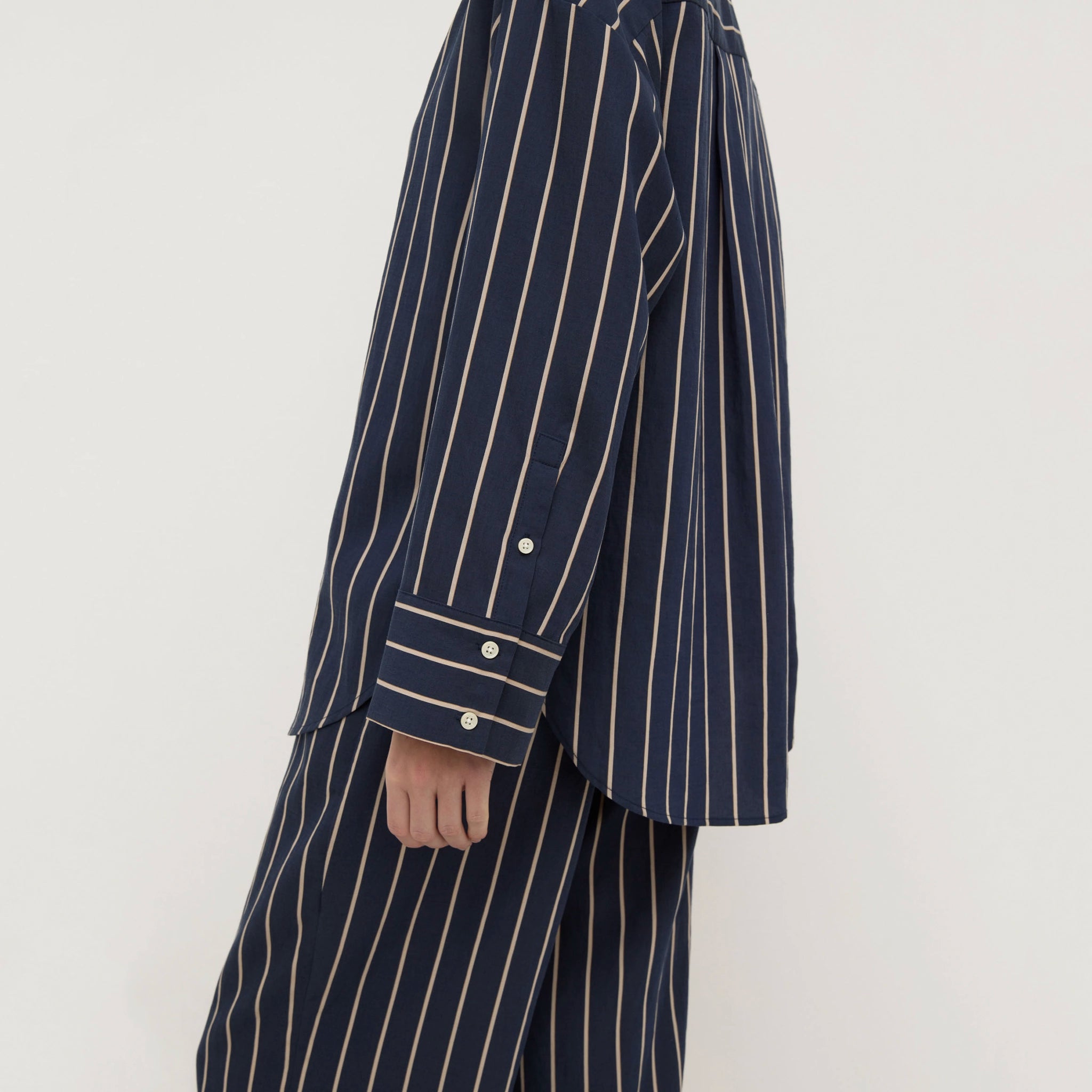 Navy pinstripe suit jacket and pants on a white background