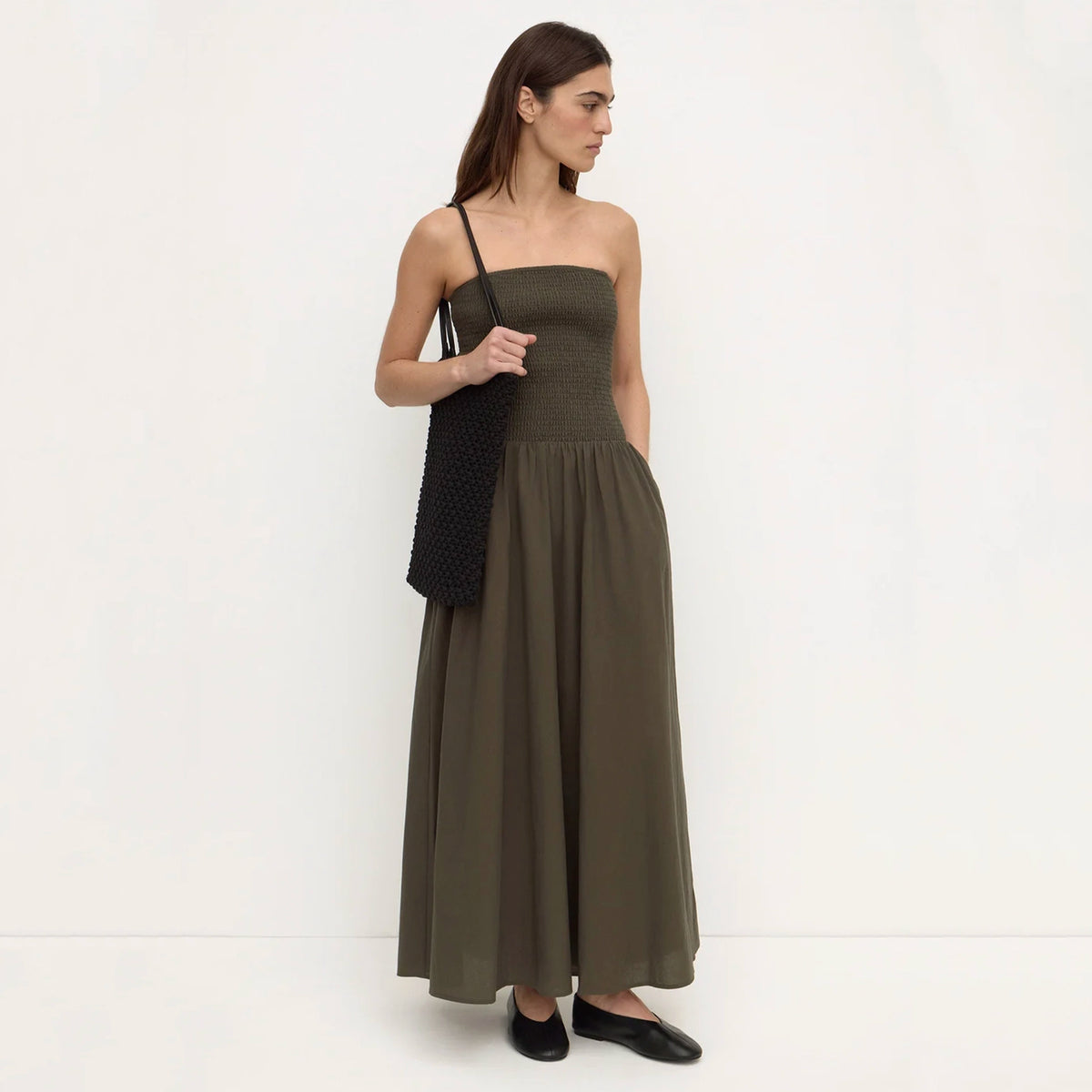 Assembly Label Connie Cotton Shirred Dress - Dark Military, side view on model carrying a black tote bag
