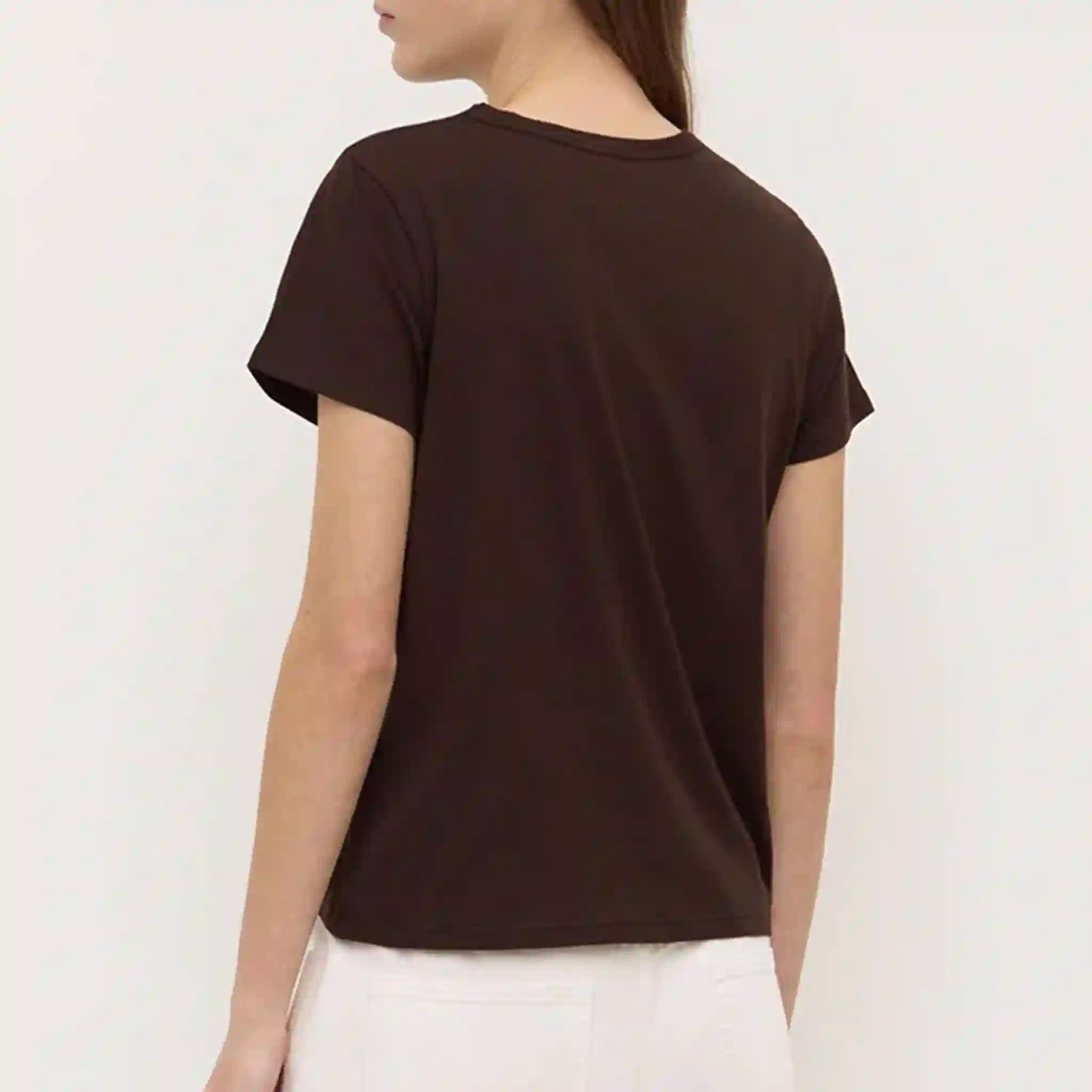 Person wearing a brown t-shirt on a plain background