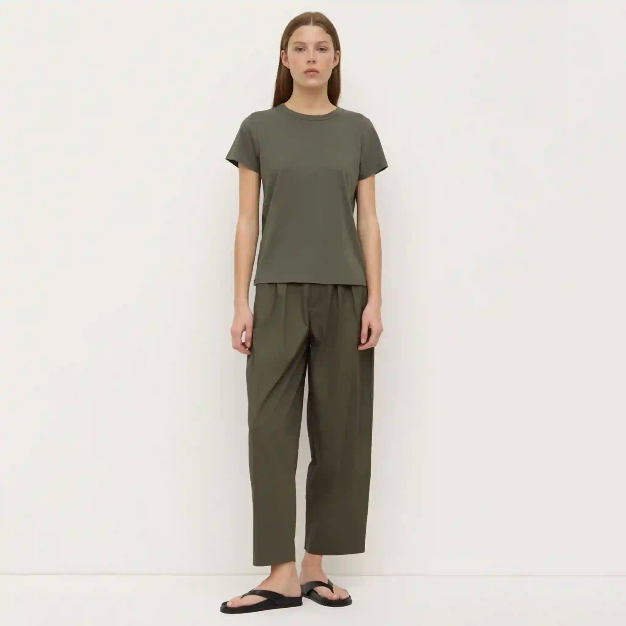 Person wearing a green outfit on a white background