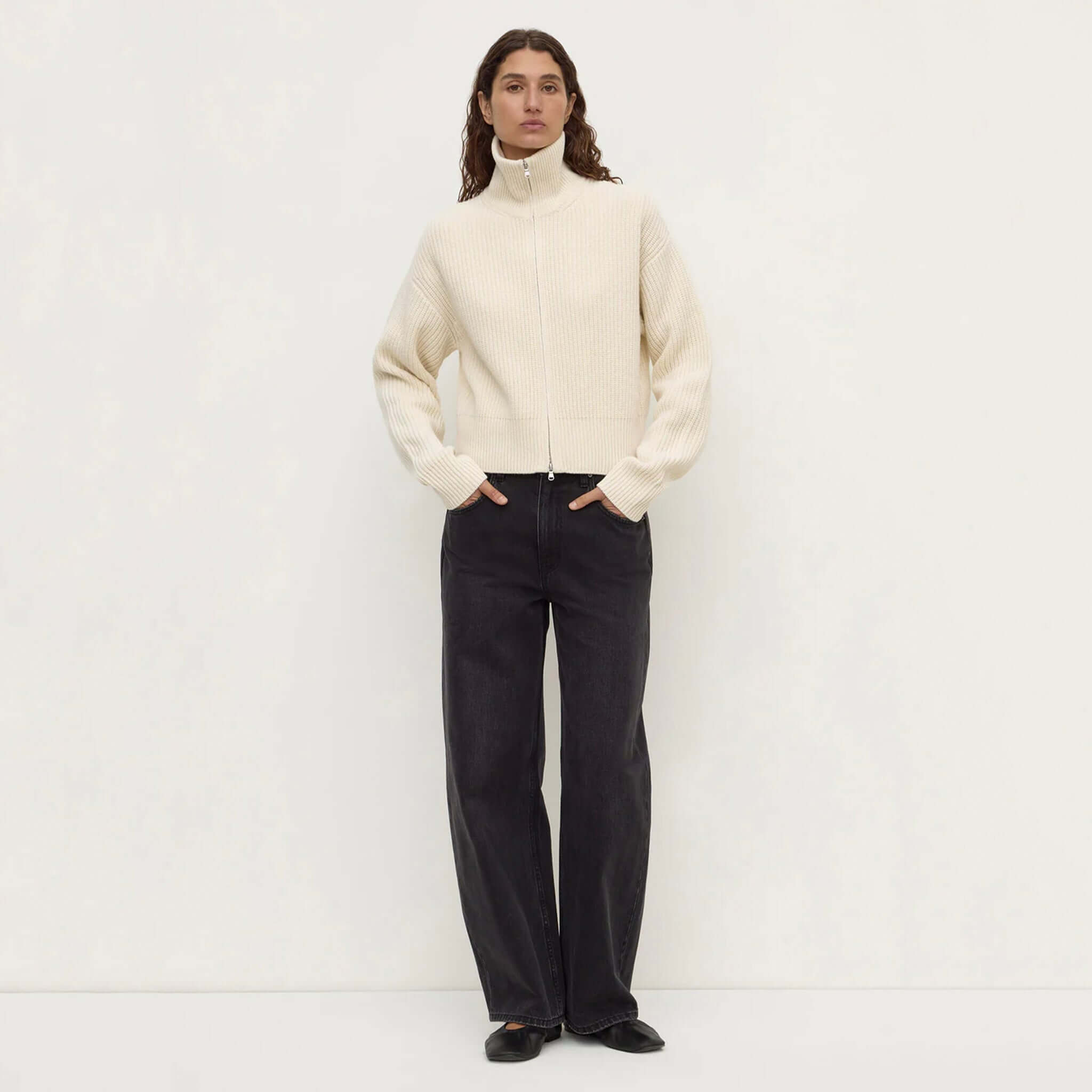 Assembly Label Kaia Wool Zip Sweater in Antique White with high-waisted jeans, showcasing a stylish look.